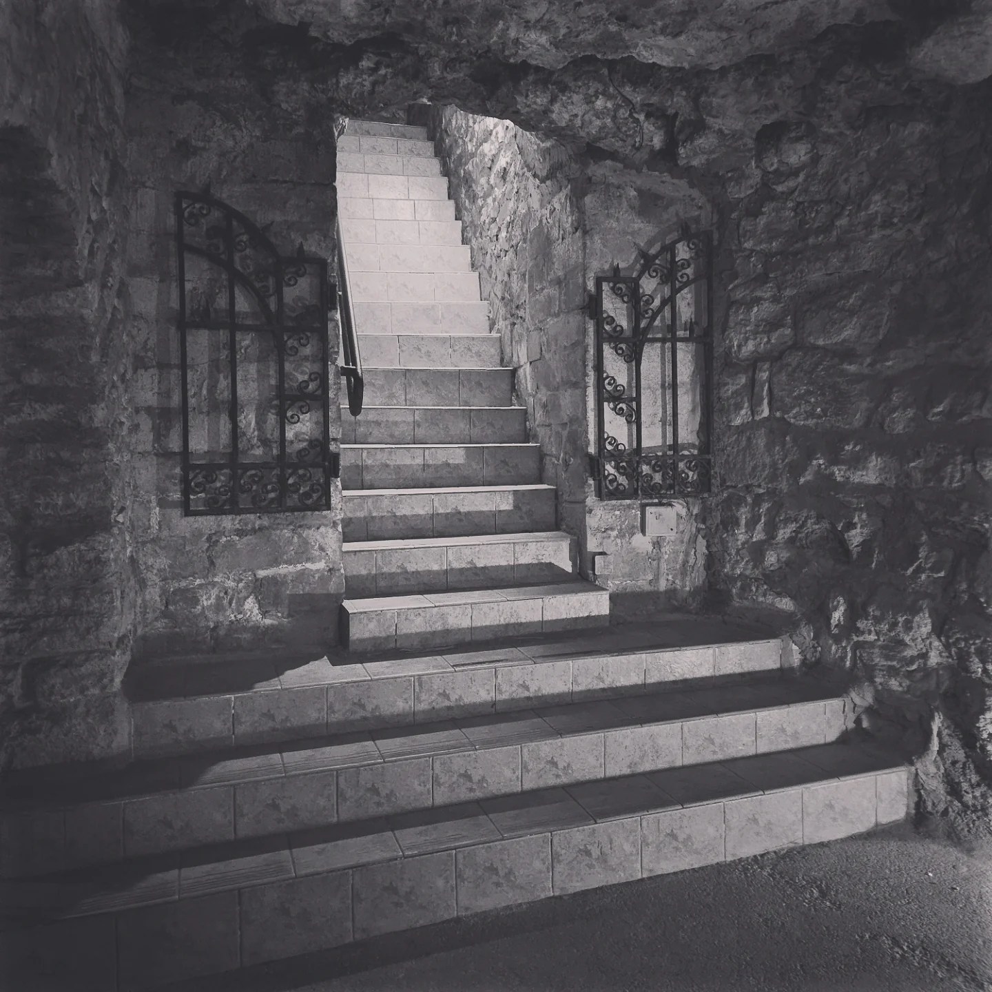 Stone stairway with wrought iron gates leading out of Stone stairway with wrought iron gates leading out of Budapest's Labirintus.