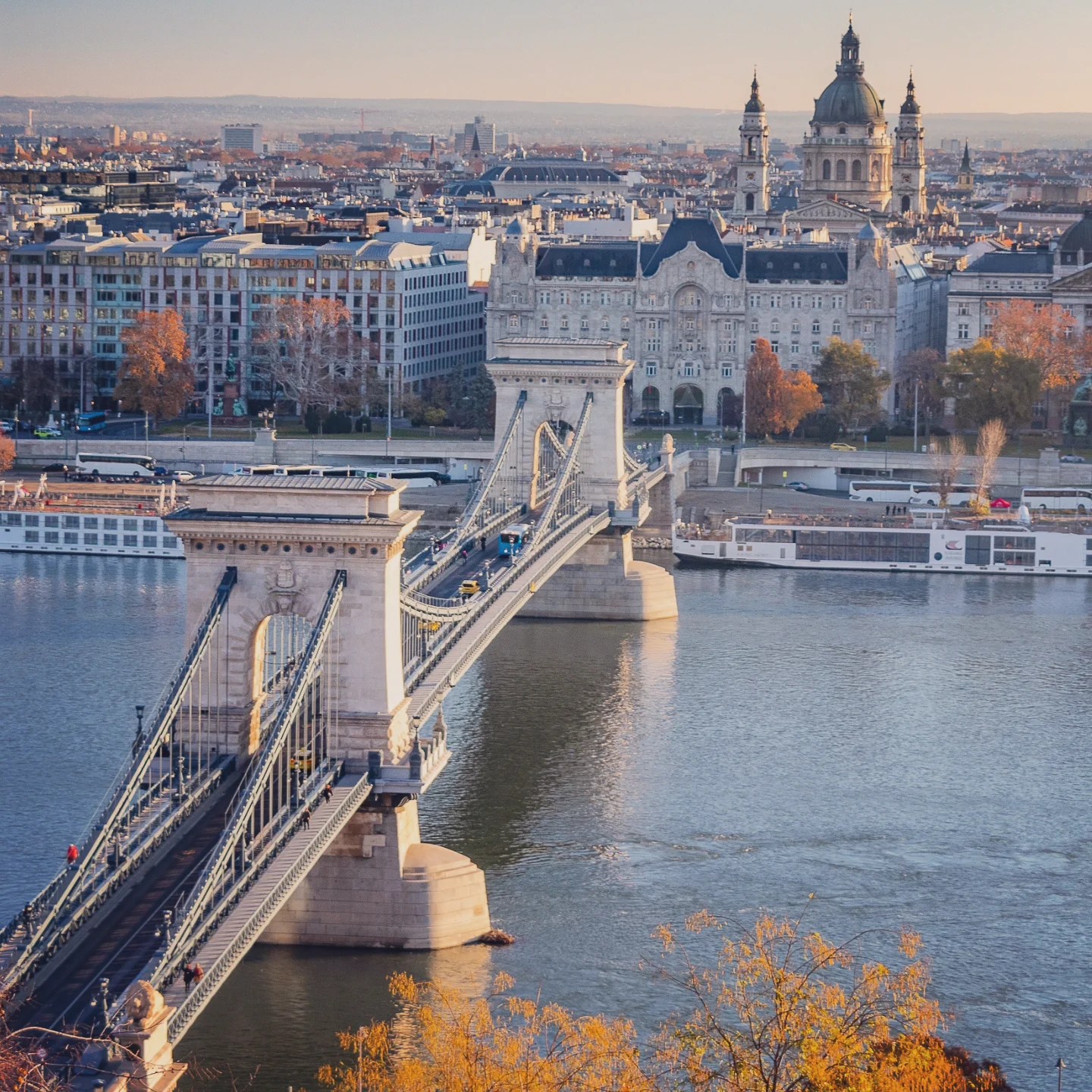 Aerial view of the Chain Bridge spanning the Danube, with St. Stephen’s Basilica and Pest in the background.