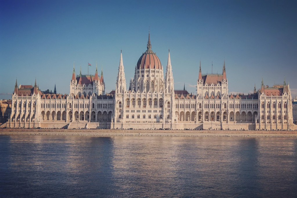 Panoramic view of the Hungarian Parliament Building along the Danube River in Budapest.