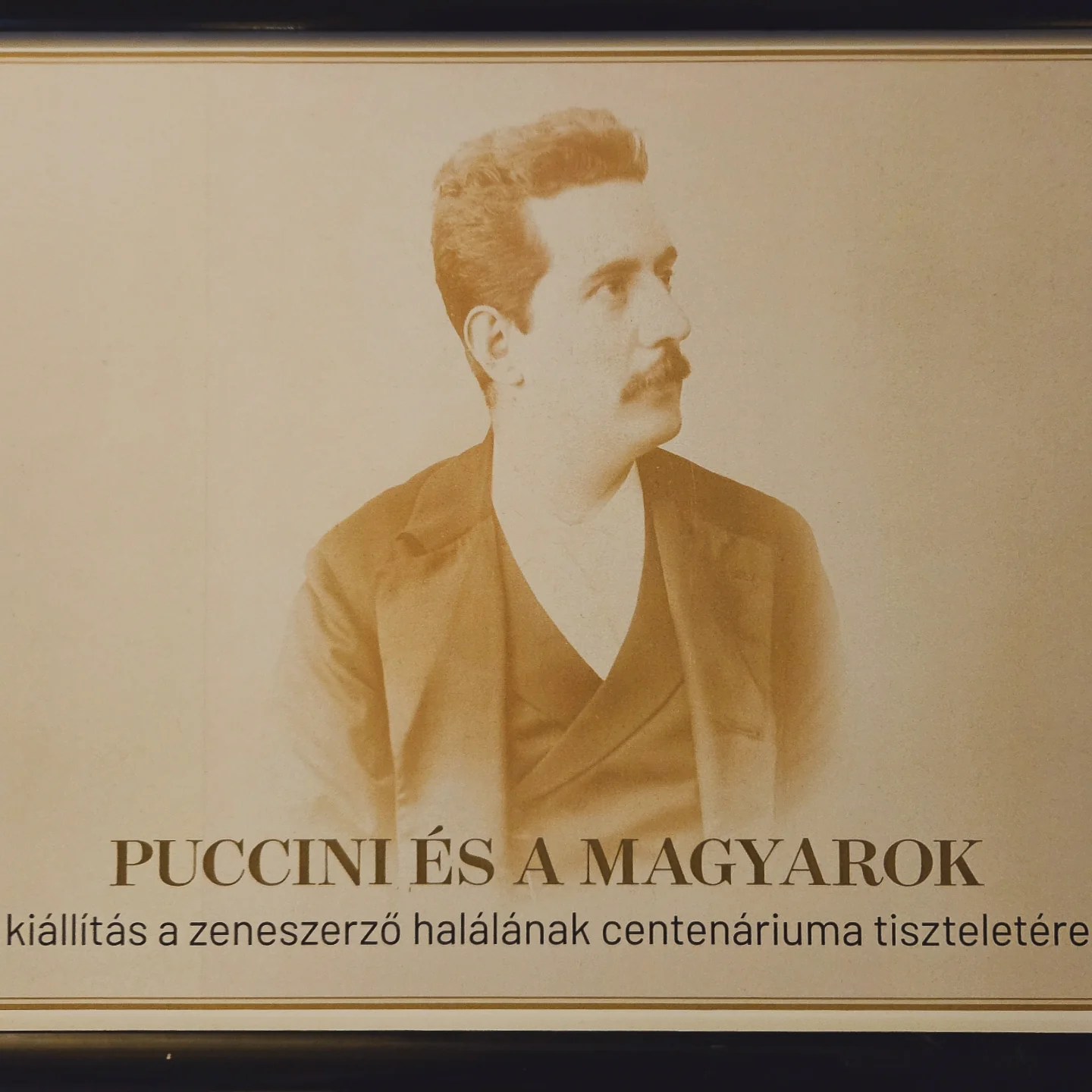 Sepia-toned portrait of Puccini from an exhibit titled “Puccini és a Magyarok.”