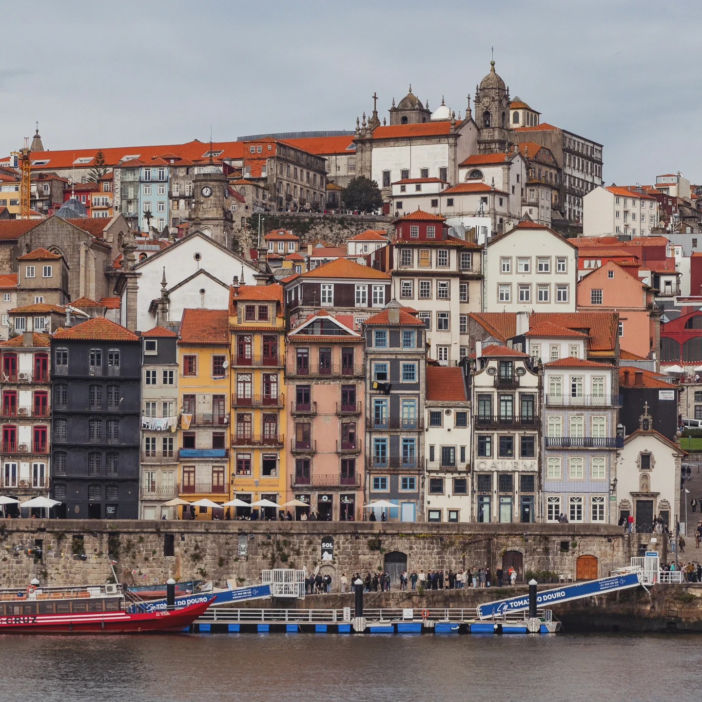 Riverside view of colorful buildings in Porto’s Ribeira district along the Douro River.