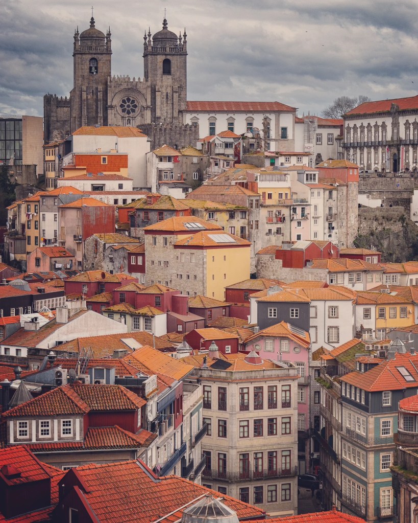 View of the Porto Cathedral with colorful houses and the Episcopal Palace in the background.