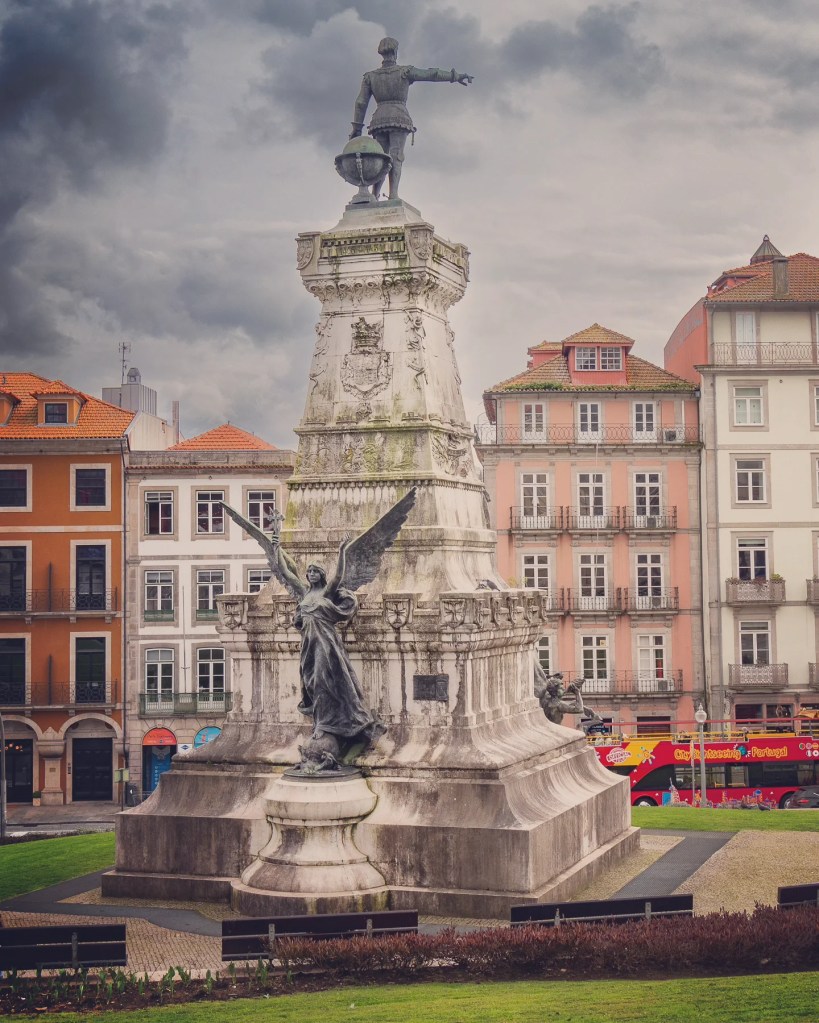 Monument to Prince Henry the Navigator in Porto’s Jardim do Infante Dom Henrique with historic buildings behind.