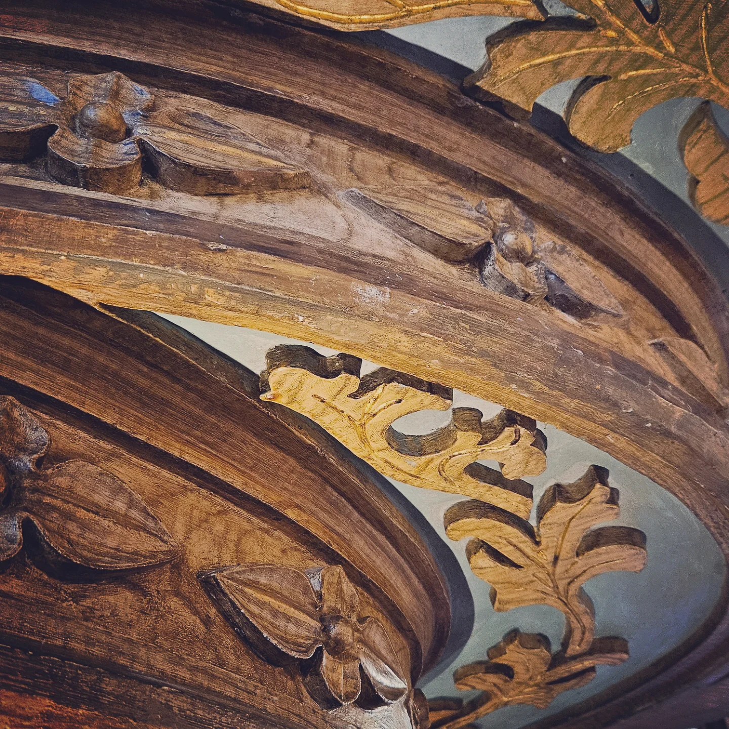 Close-up of detailed wooden carving on a column or staircase in Livraria Lello.