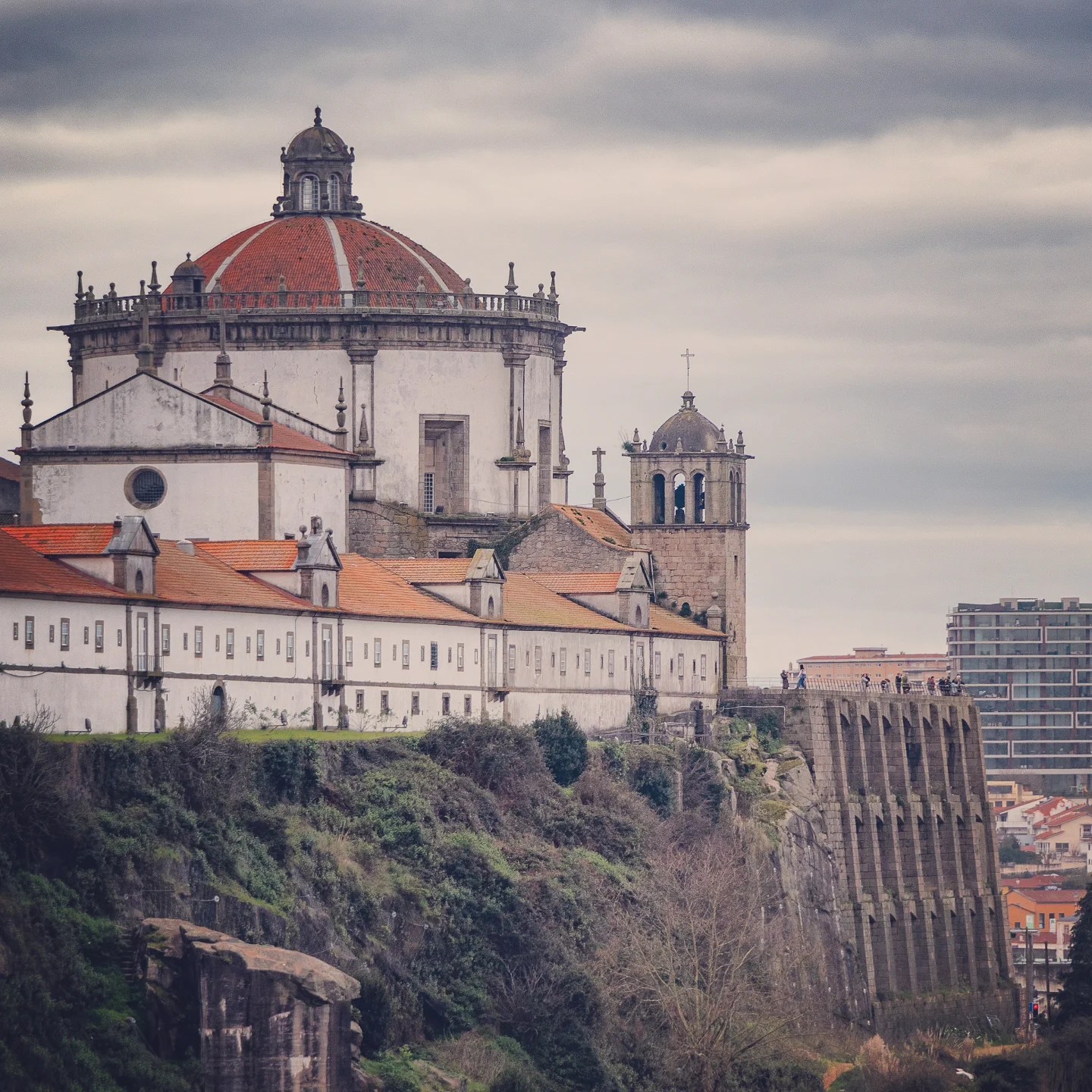 The domed Serra do Pilar Monastery seen from across the river, framed against a moody sky in Porto.