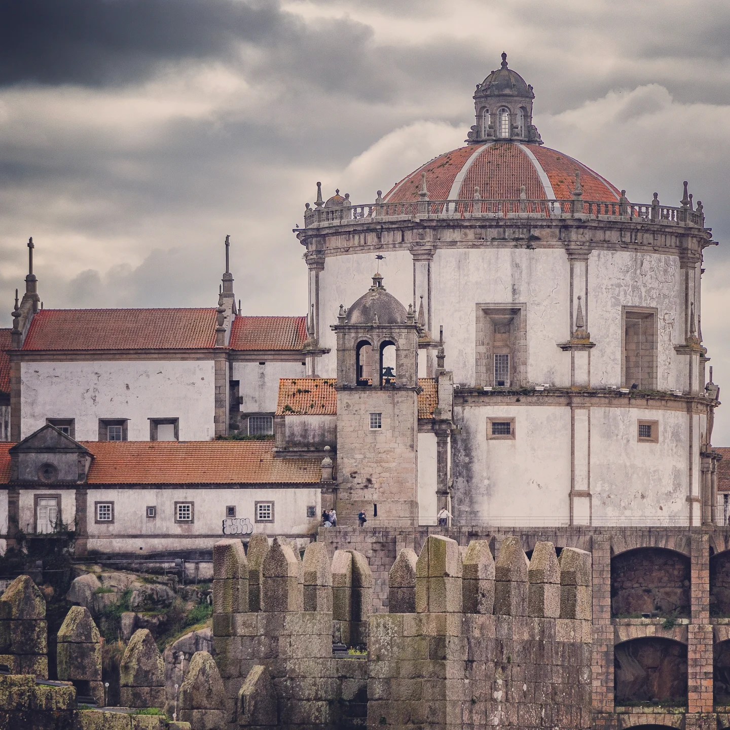 Close-up view of the Serra do Pilar Monastery in Porto, showing its round dome and weathered stone walls.