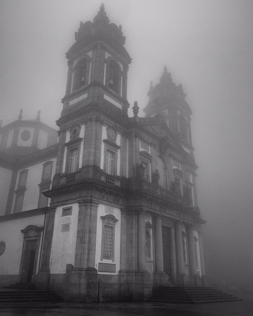 Foggy side view of the Sanctuary of Bom Jesus do Monte with Baroque twin towers in Braga, Portugal.