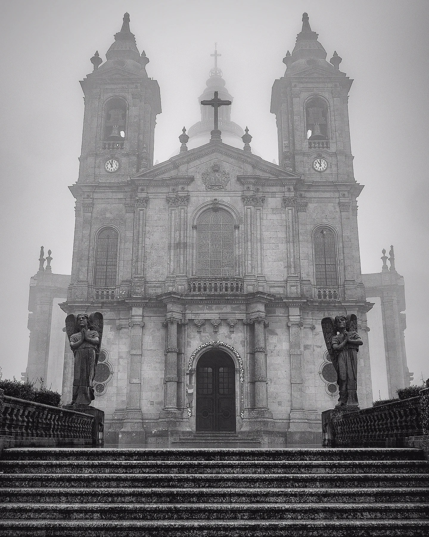 Front façade of the Sanctuary of Our Lady of Sameiro (Santuário do Sameiro) shrouded in fog near Braga, Portugal.