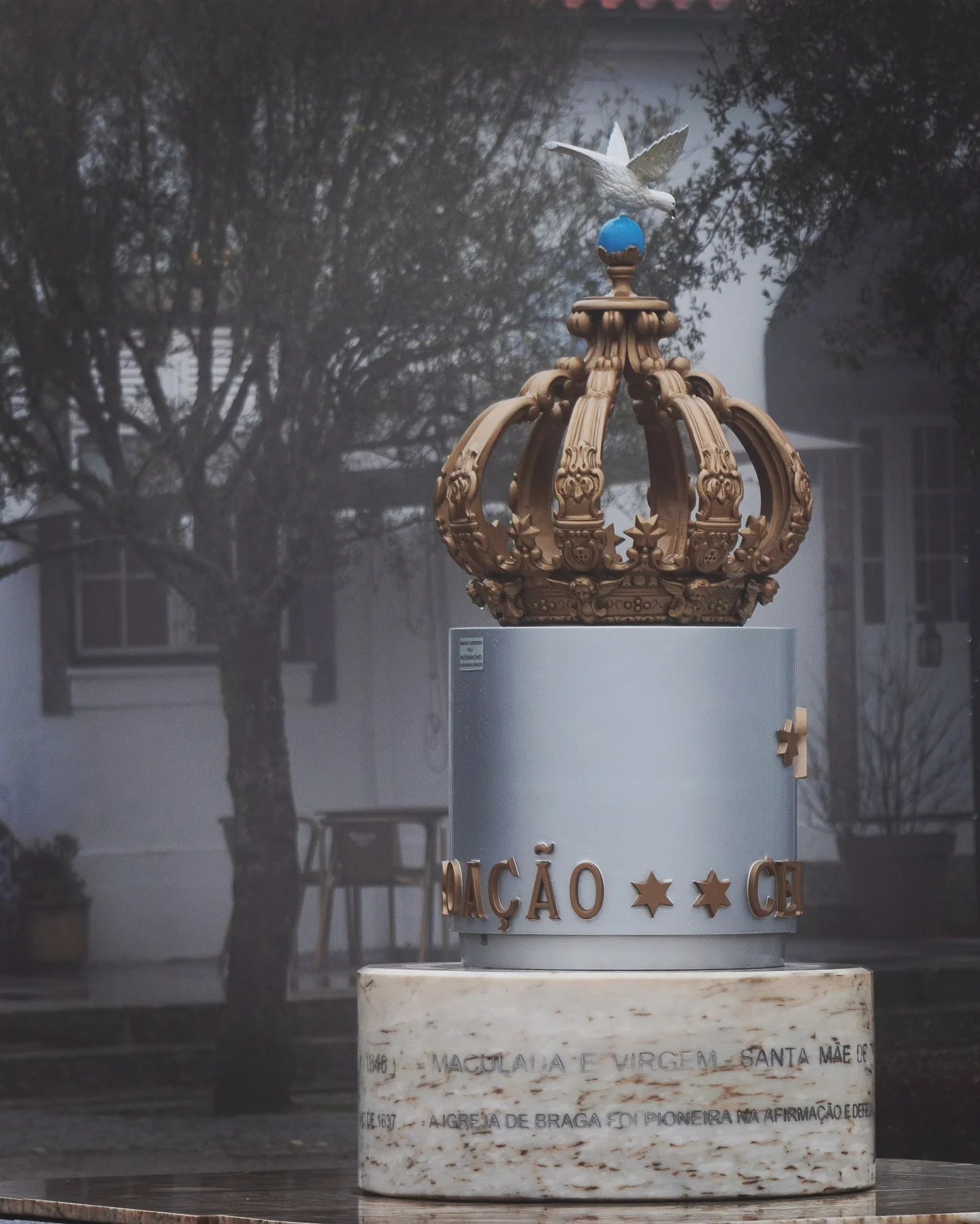Large decorative sculpture of a golden crown topped with a dove at Sameiro Sanctuary in Braga, Portugal.