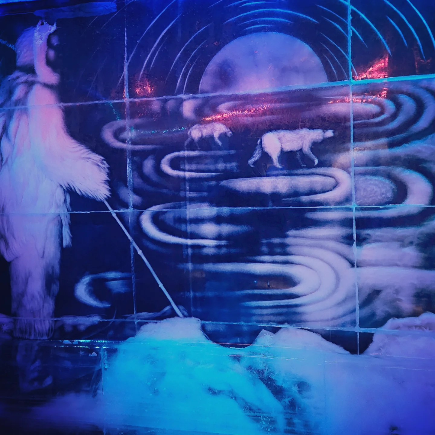 A hauntingly beautiful mural, depicting a figure walking alongside polar bears under a glowing moon and aurora-like sky.