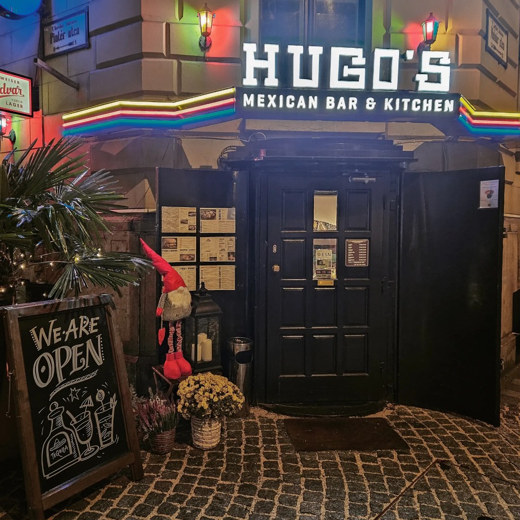 Exterior of Hugo’s Mexican Bar & Kitchen in Budapest decorated with lights and a gnome.