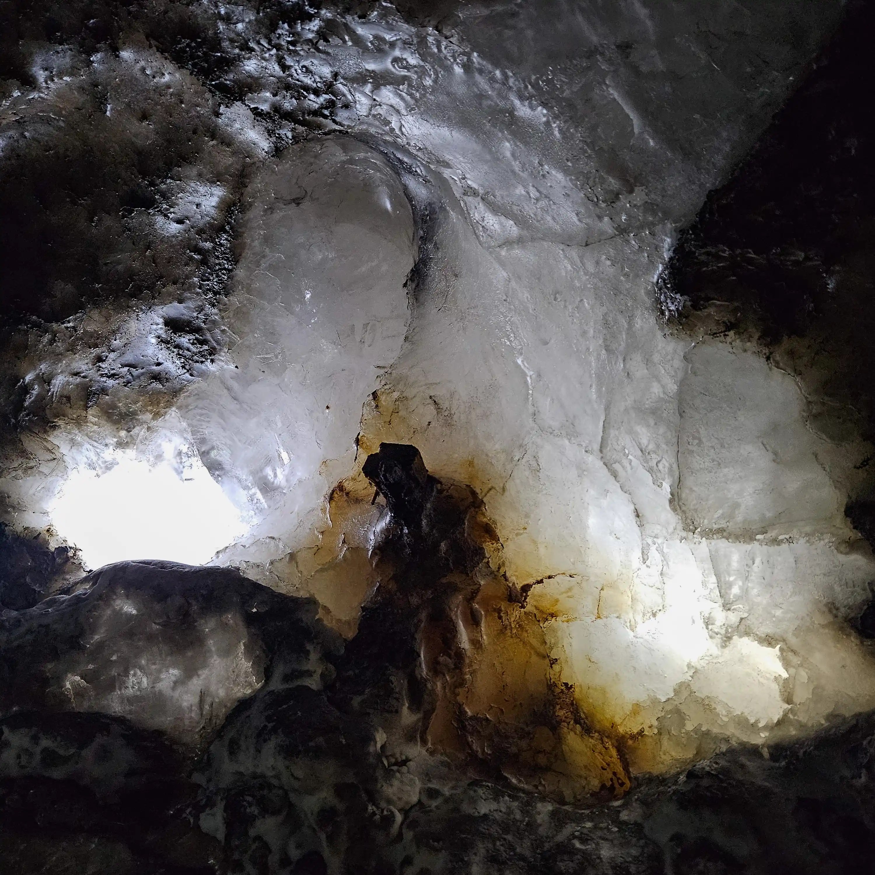 Close-up of a salt wall inside the mine, illuminated to reveal white, gray, and amber tones.