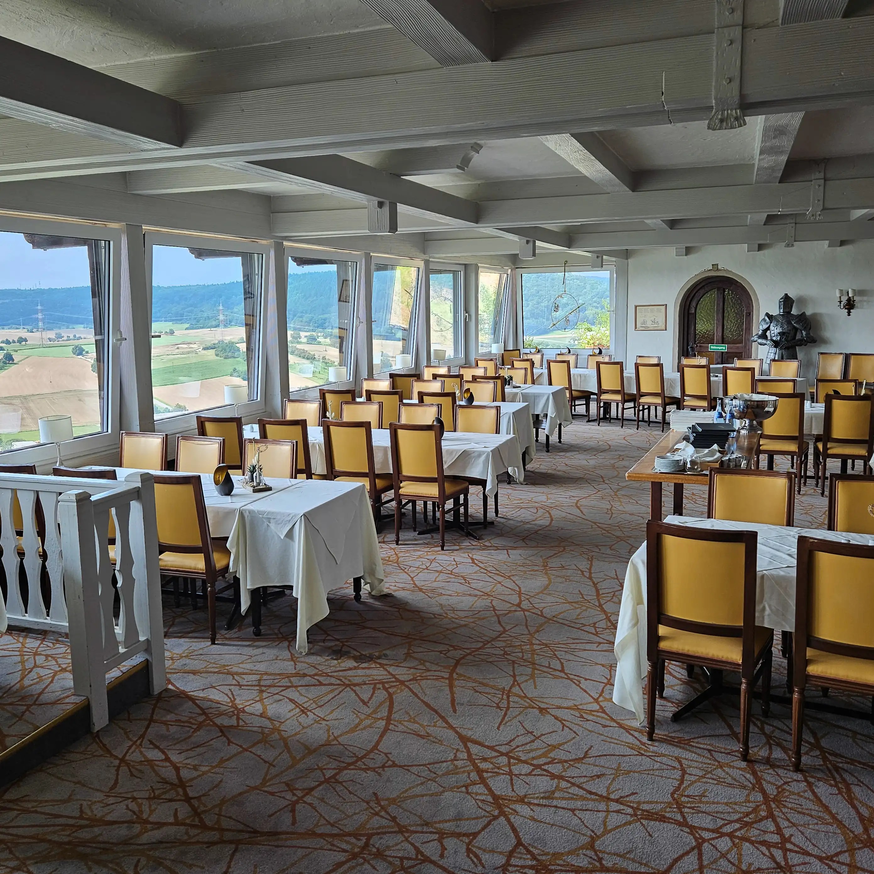 Dining room at Burg Hornberg with panoramic windows over the Neckar Valley.