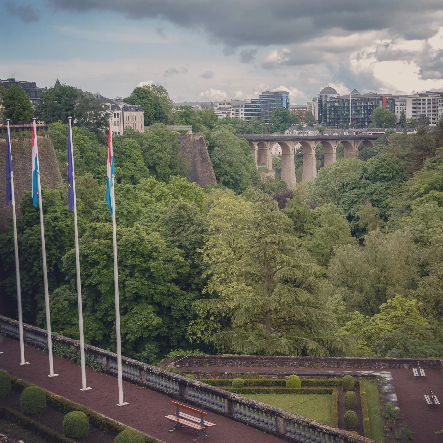 Luxembourg and EU flags with the Adolphe Bridge in the background.