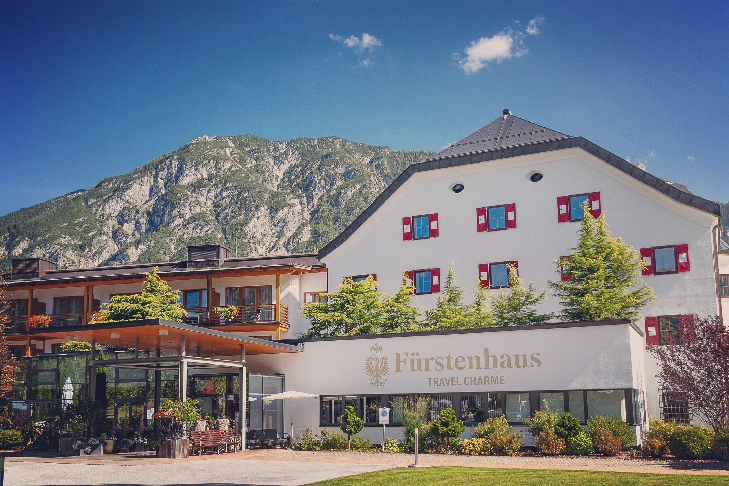 Fürstenhaus Travel Charme hotel in Pertisau framed by rocky mountains.