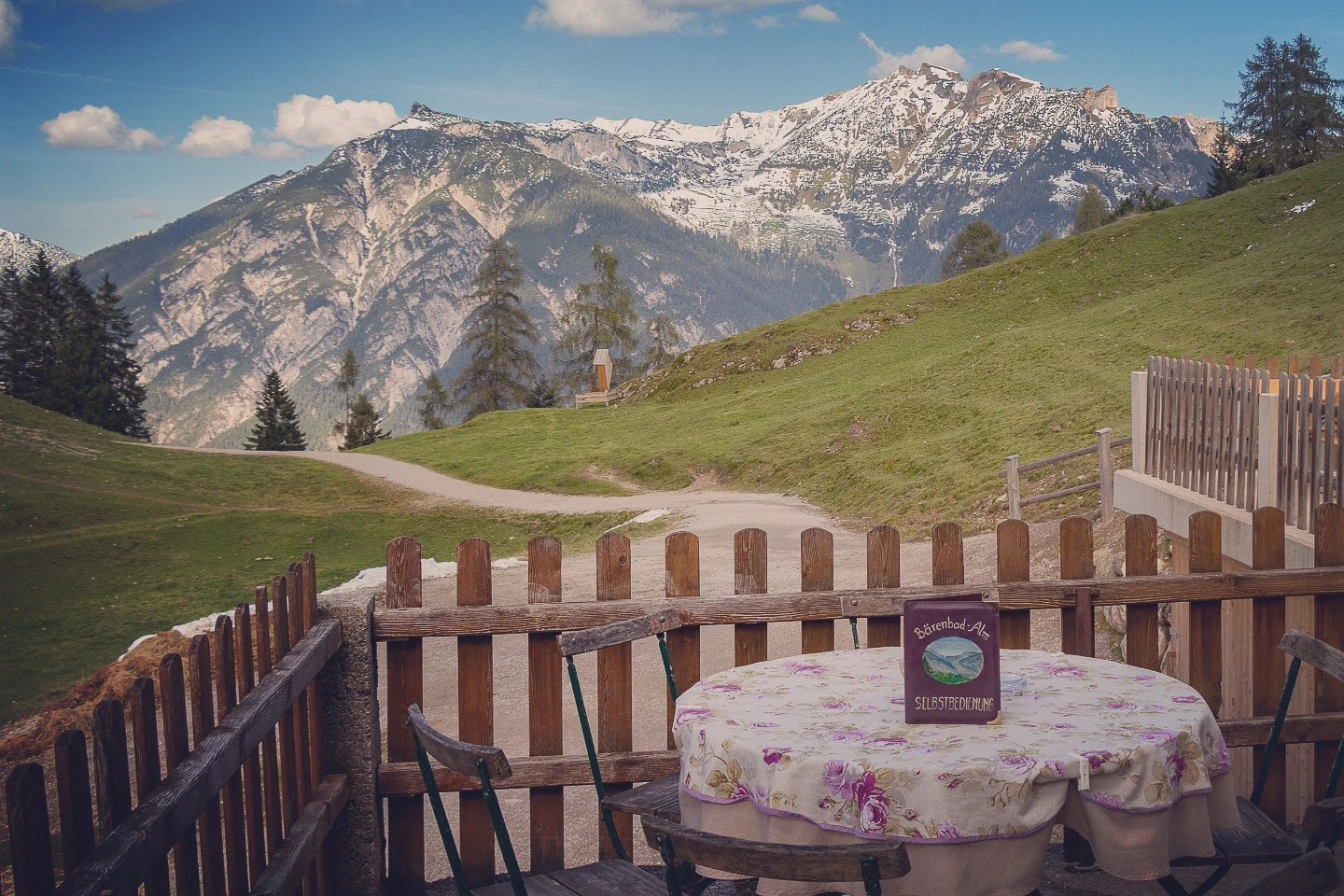 Rustic alpine hut terrace with table and sweeping mountain scenery near Achensee, Tyrol.