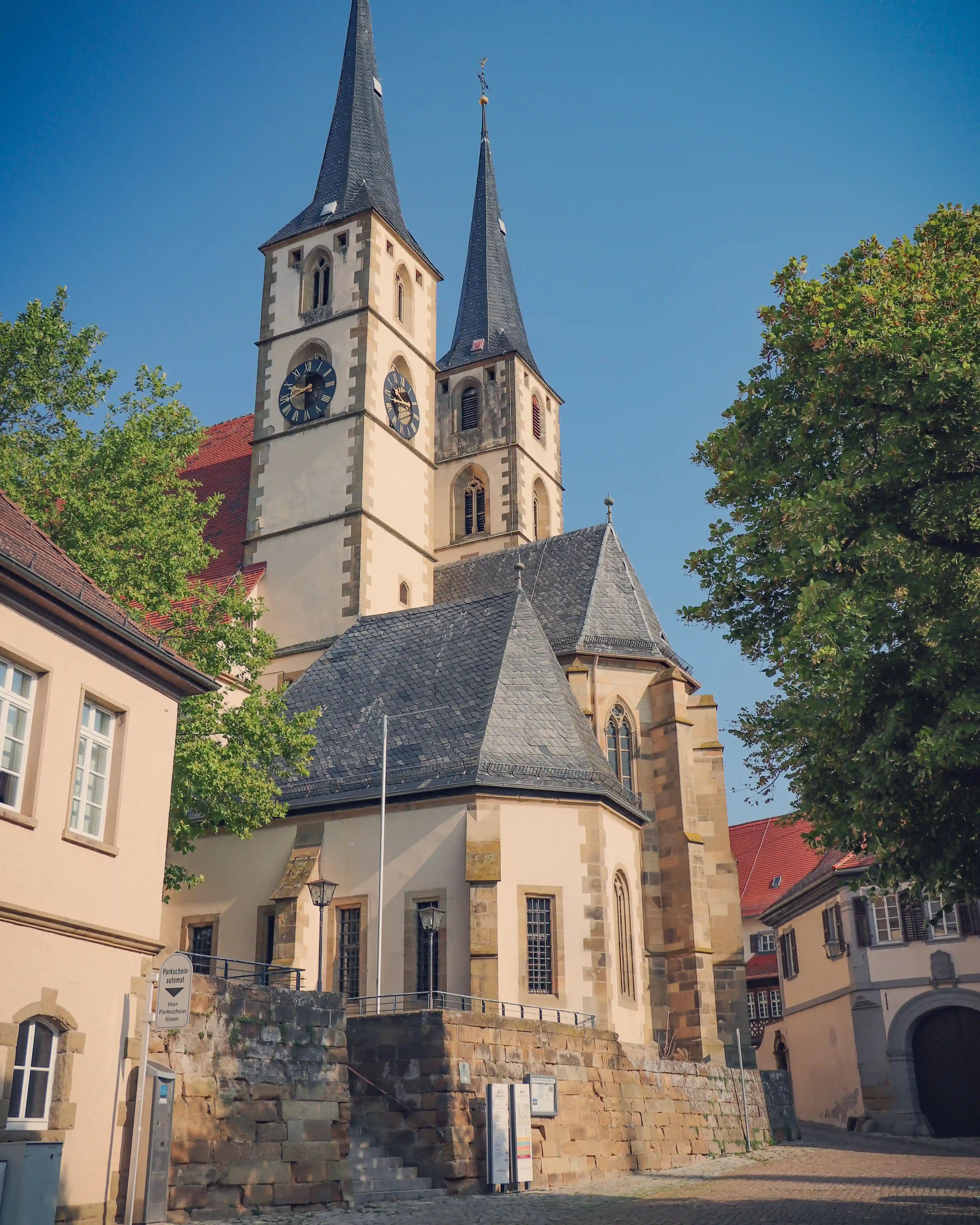 Twin-spired parish church with slate roofs above the old town, Bad Wimpfen, Germany.