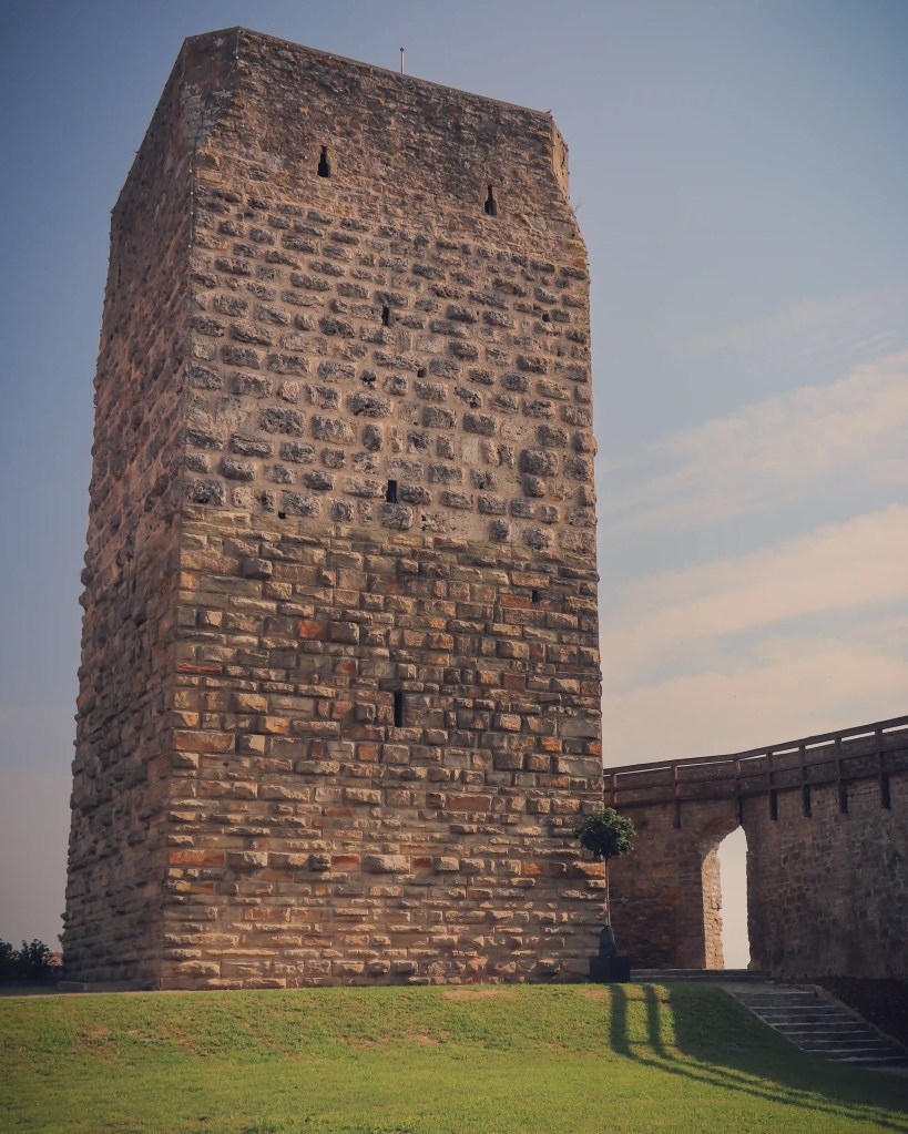 Massive square medieval stone tower and walkway on the hilltop fortifications, Bad Wimpfen.