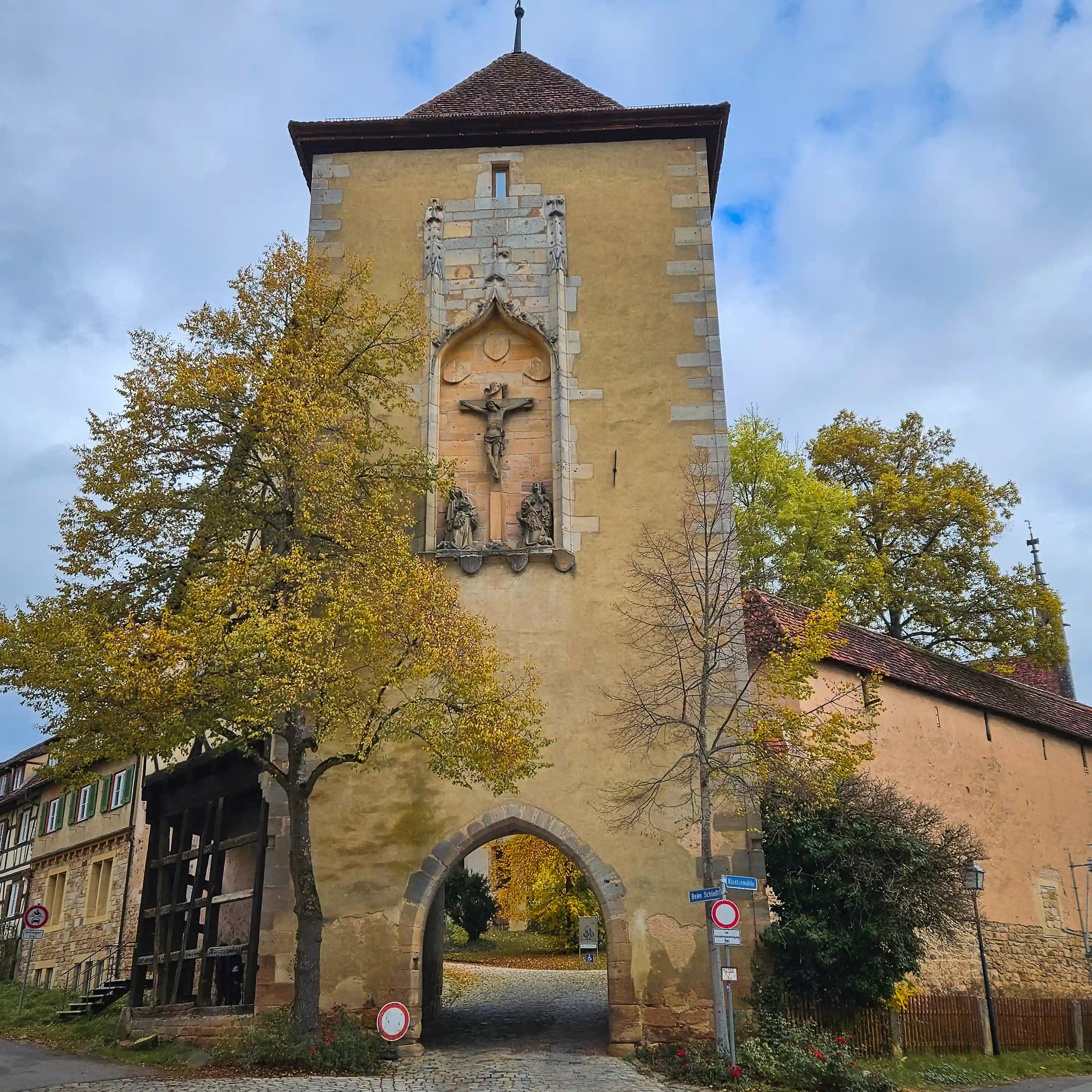 Tower gate with crucifixion relief above arched entrance at Bebenhausen.