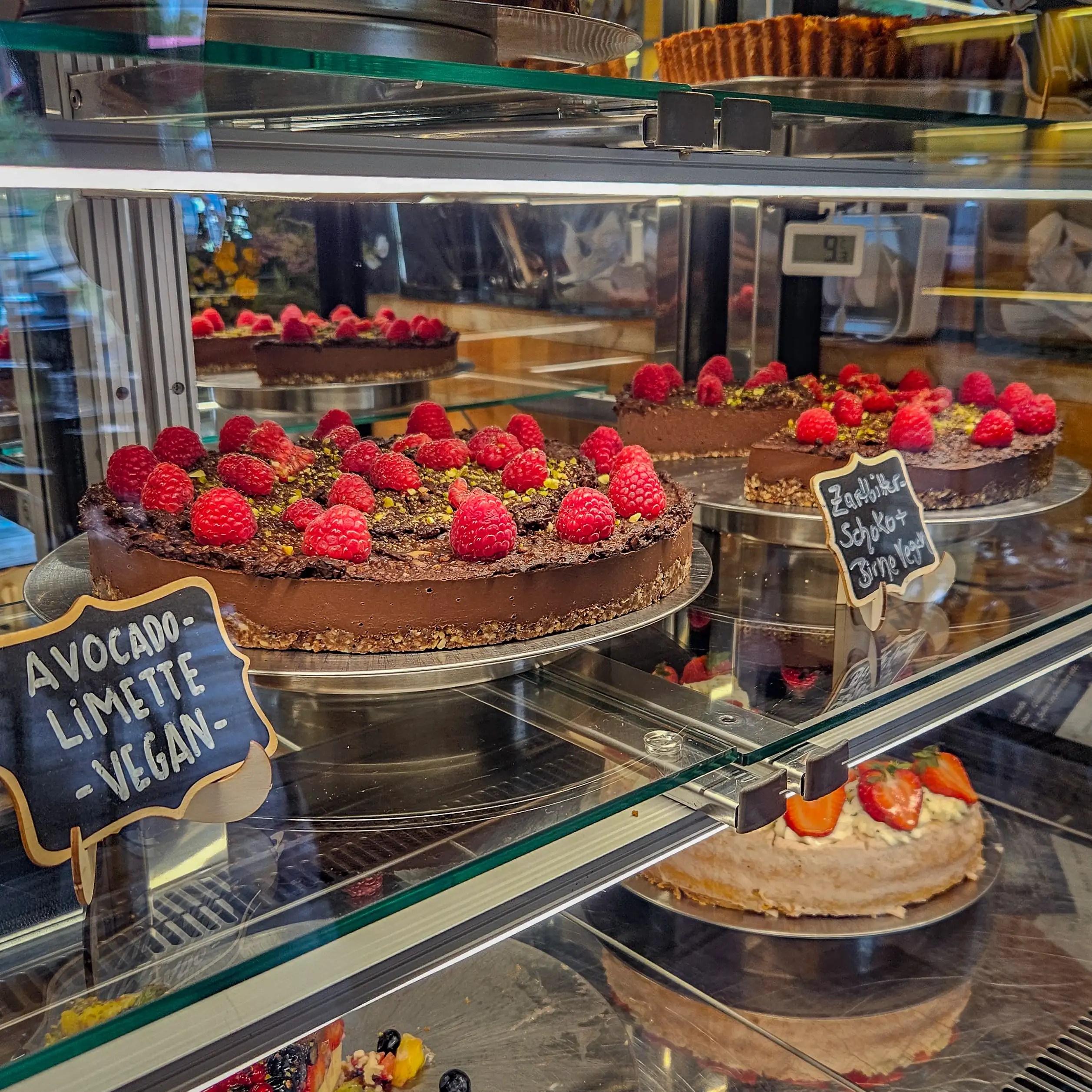 Chocolate cakes topped with fresh raspberries on display at Café im Kloster.
