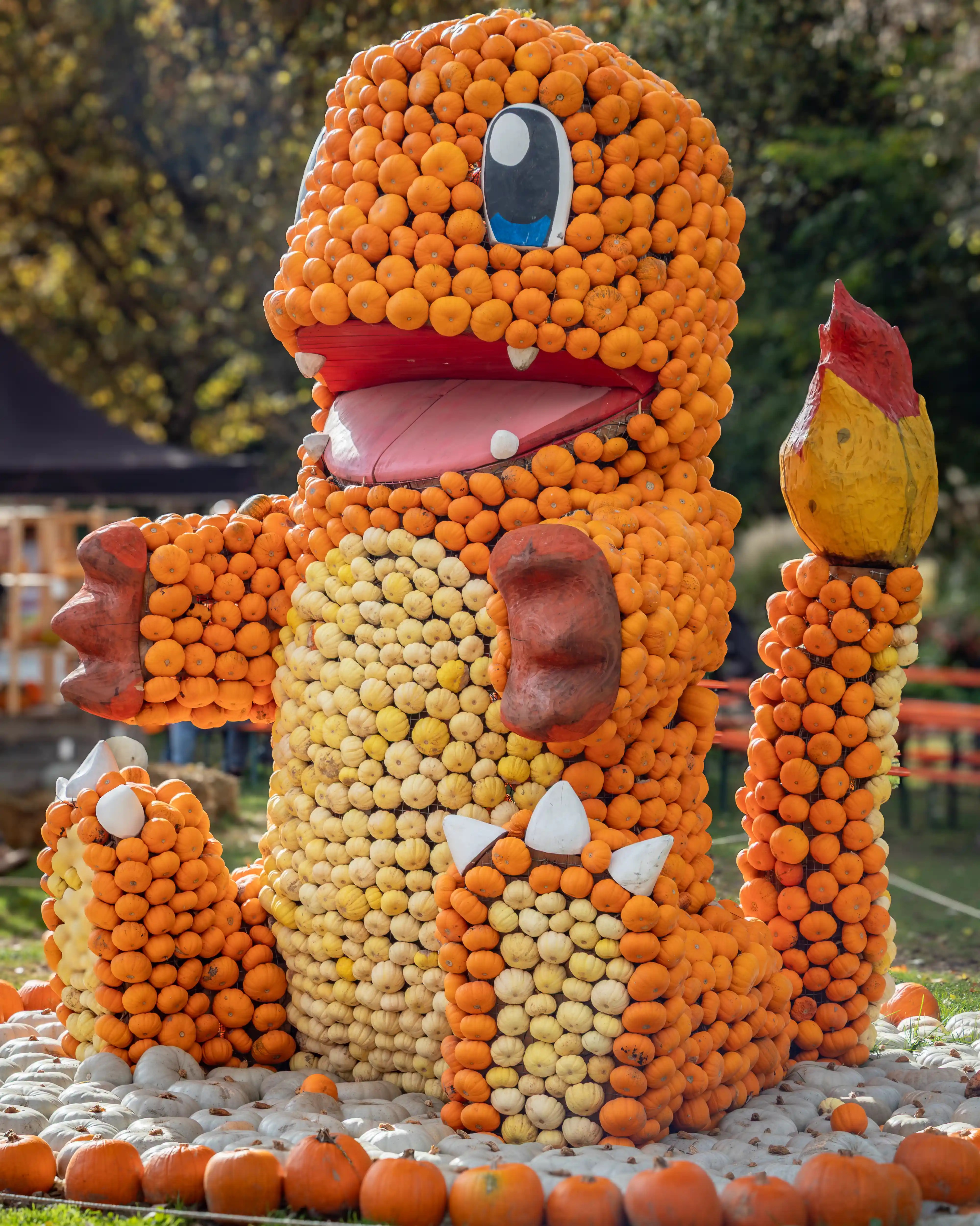 Giant Charmander Pokémon sculpture made entirely from pumpkins and gourds.