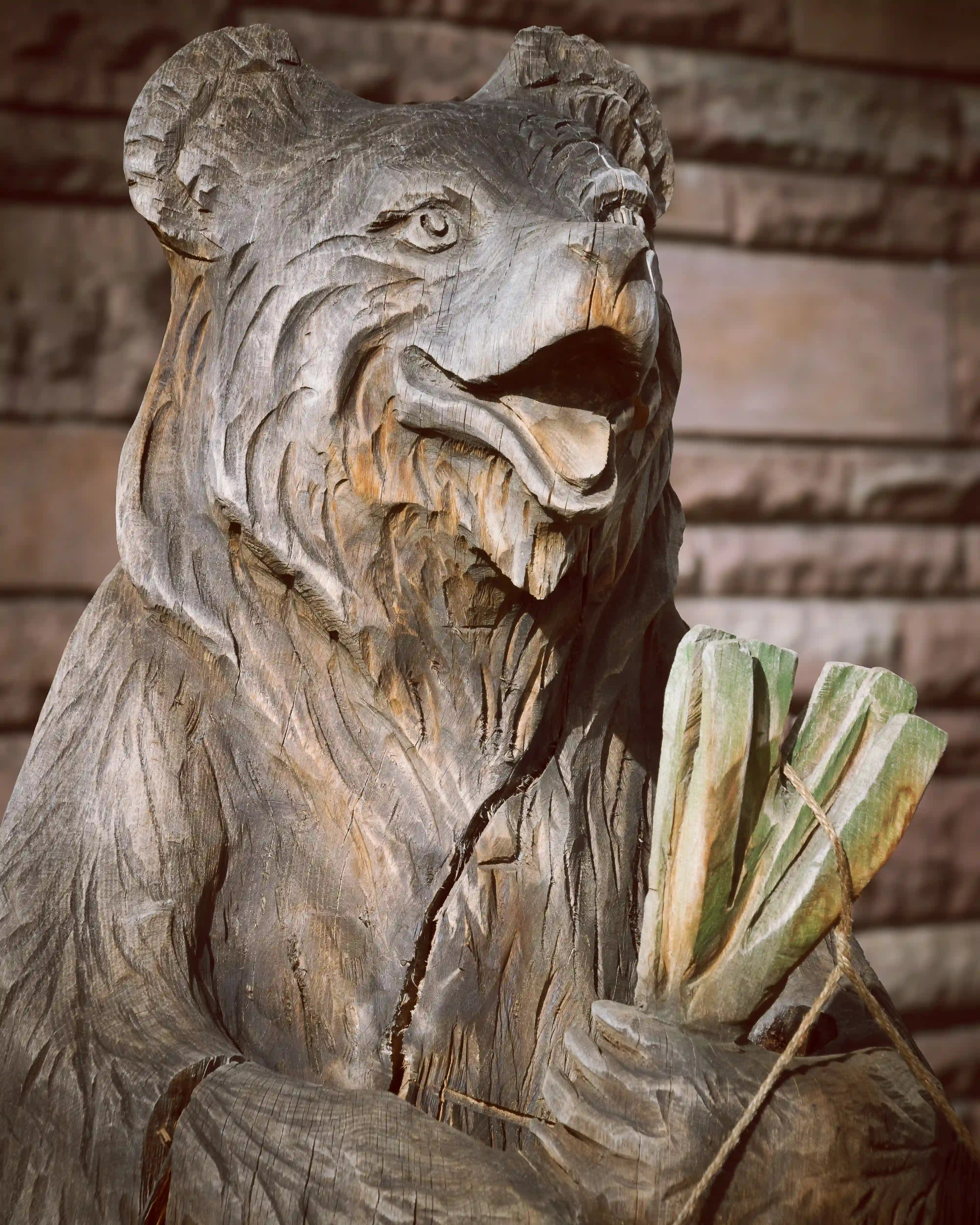 Wooden bear sculpture holding vegetables at the Ludwigsburg Pumpkin Festival.