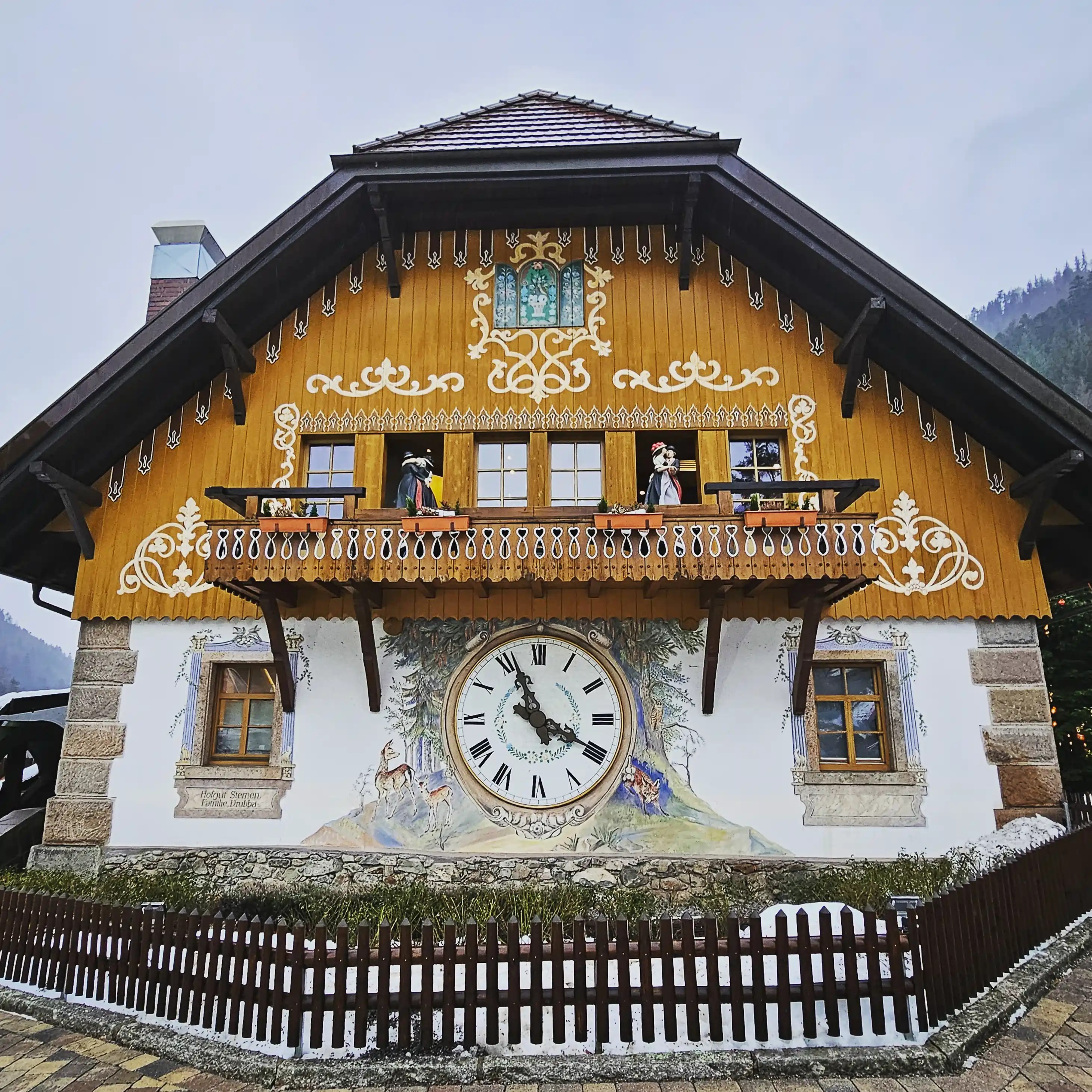 Large decorated building featuring a massive cuckoo clock and painted forest scene near Hofgut Sternen.
