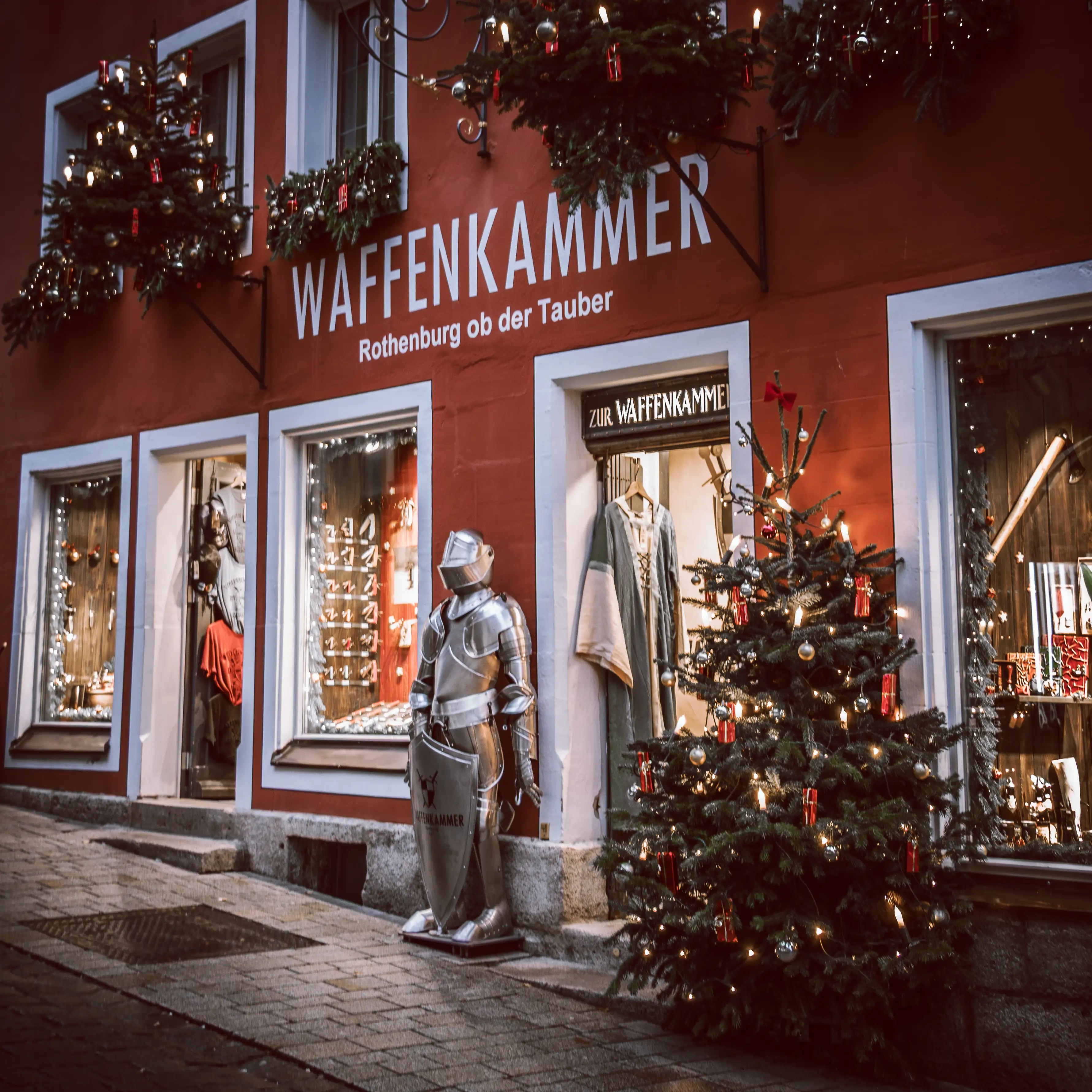 Waffenkammer shop in Rothenburg ob der Tauber with a suit of armor, medieval clothing displays, and a Christmas tree.
