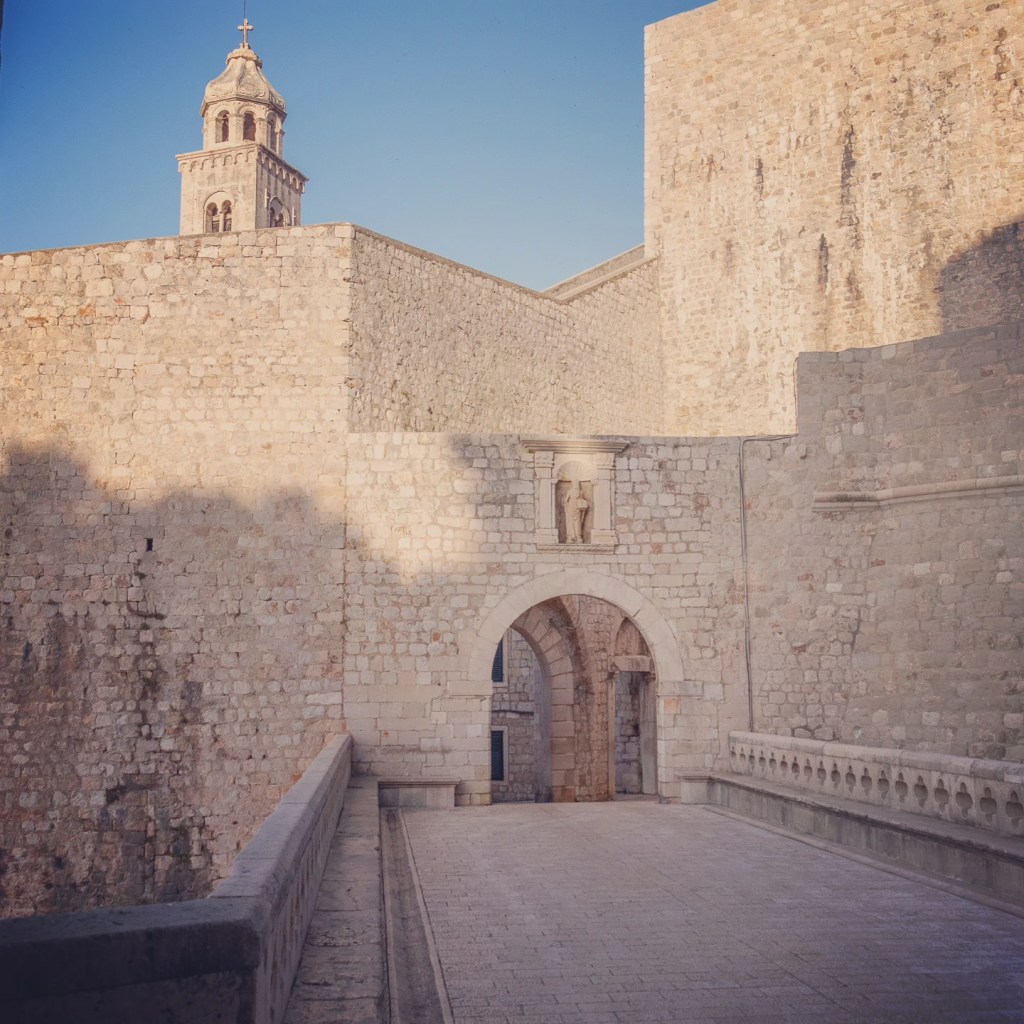 Ploče Gate entrance to Dubrovnik’s Old Town with the Dominican Monastery bell tower in the background.