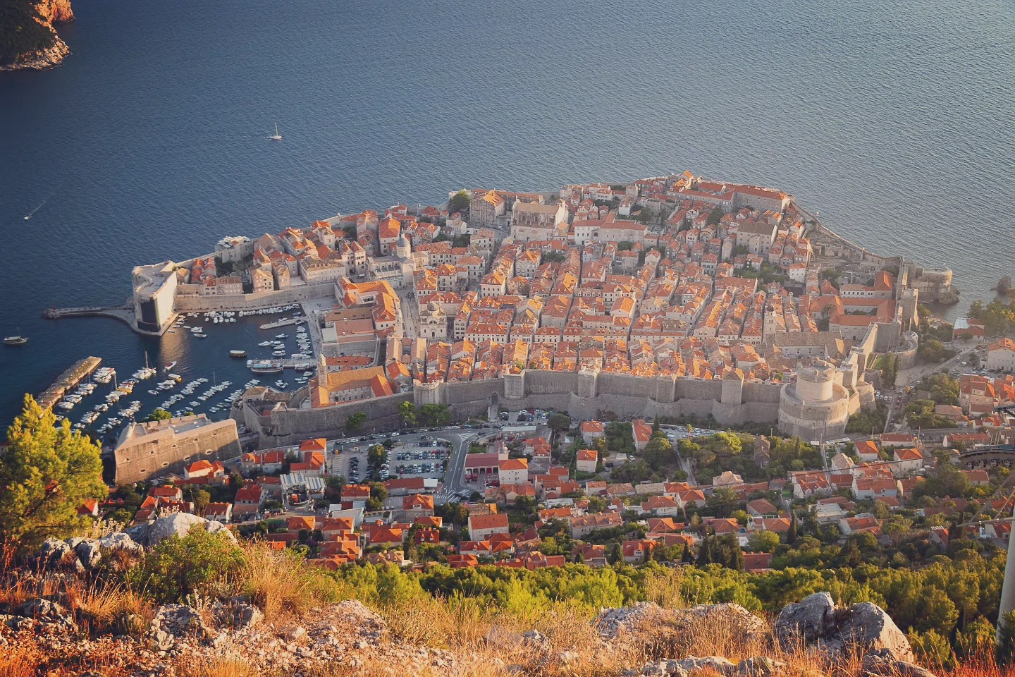 Aerial view of Dubrovnik’s Old Town surrounded by medieval walls beside the Adriatic Sea.
