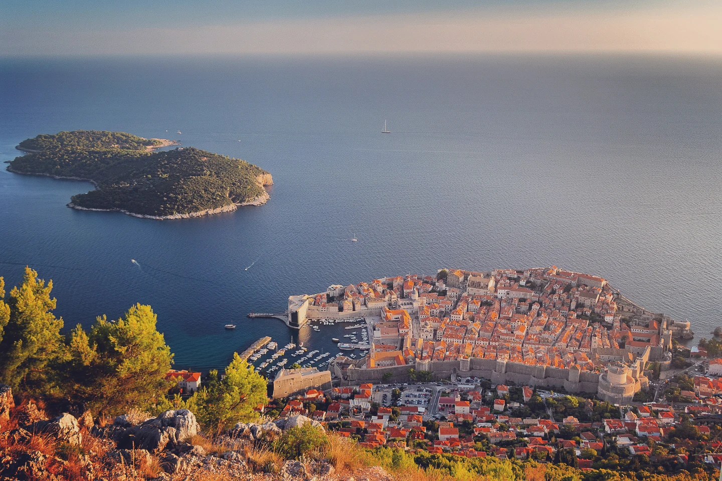 Panoramic view of Dubrovnik’s walled city and nearby Lokrum Island across the Adriatic Sea.