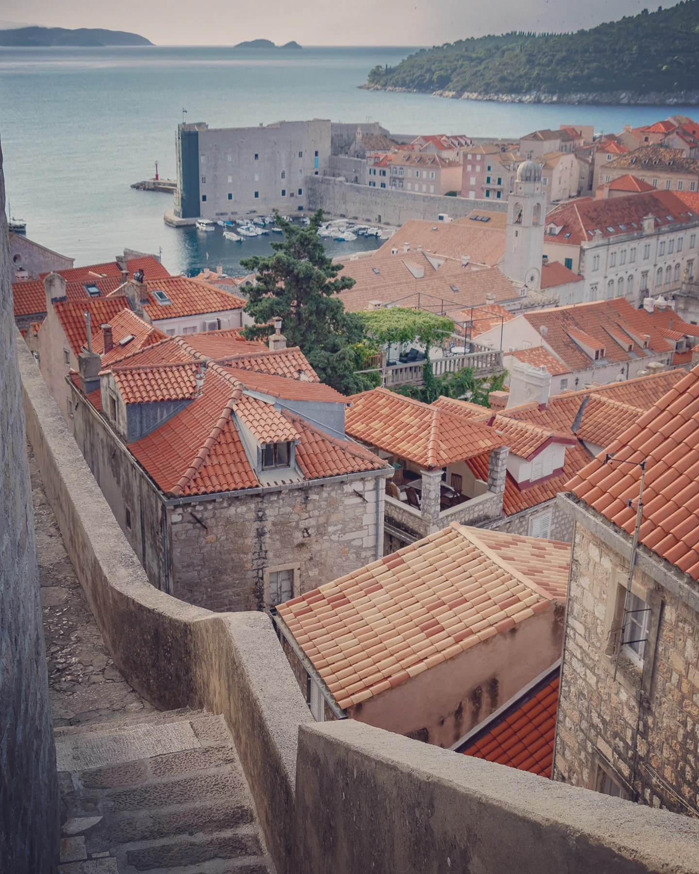 View over Dubrovnik’s terracotta rooftops toward the Old Harbor and Lokrum Island.