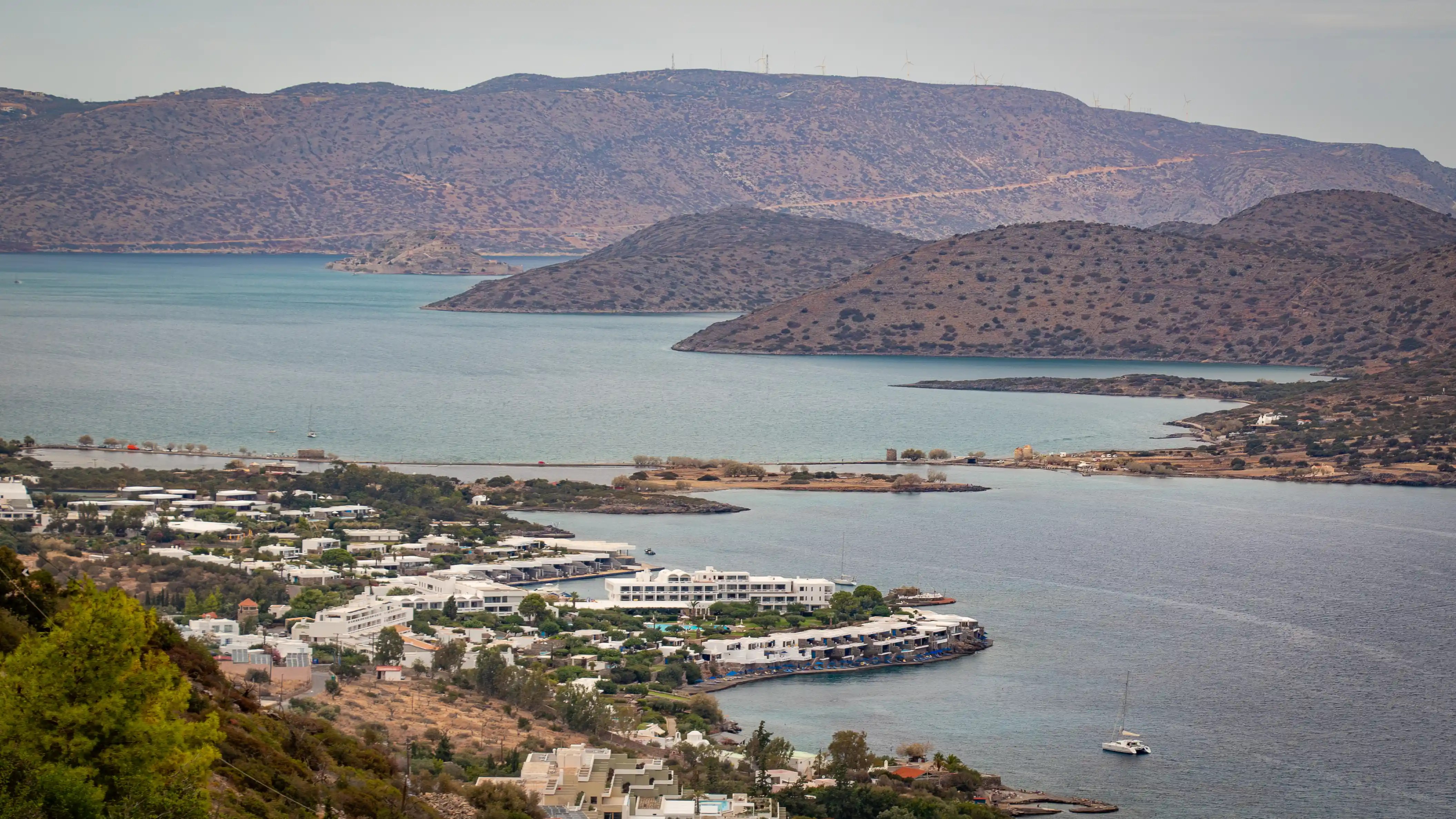 A hillside view overlooking Elounda and the causeway leading to the Spinalonga Peninsula on Crete’s northern coast.