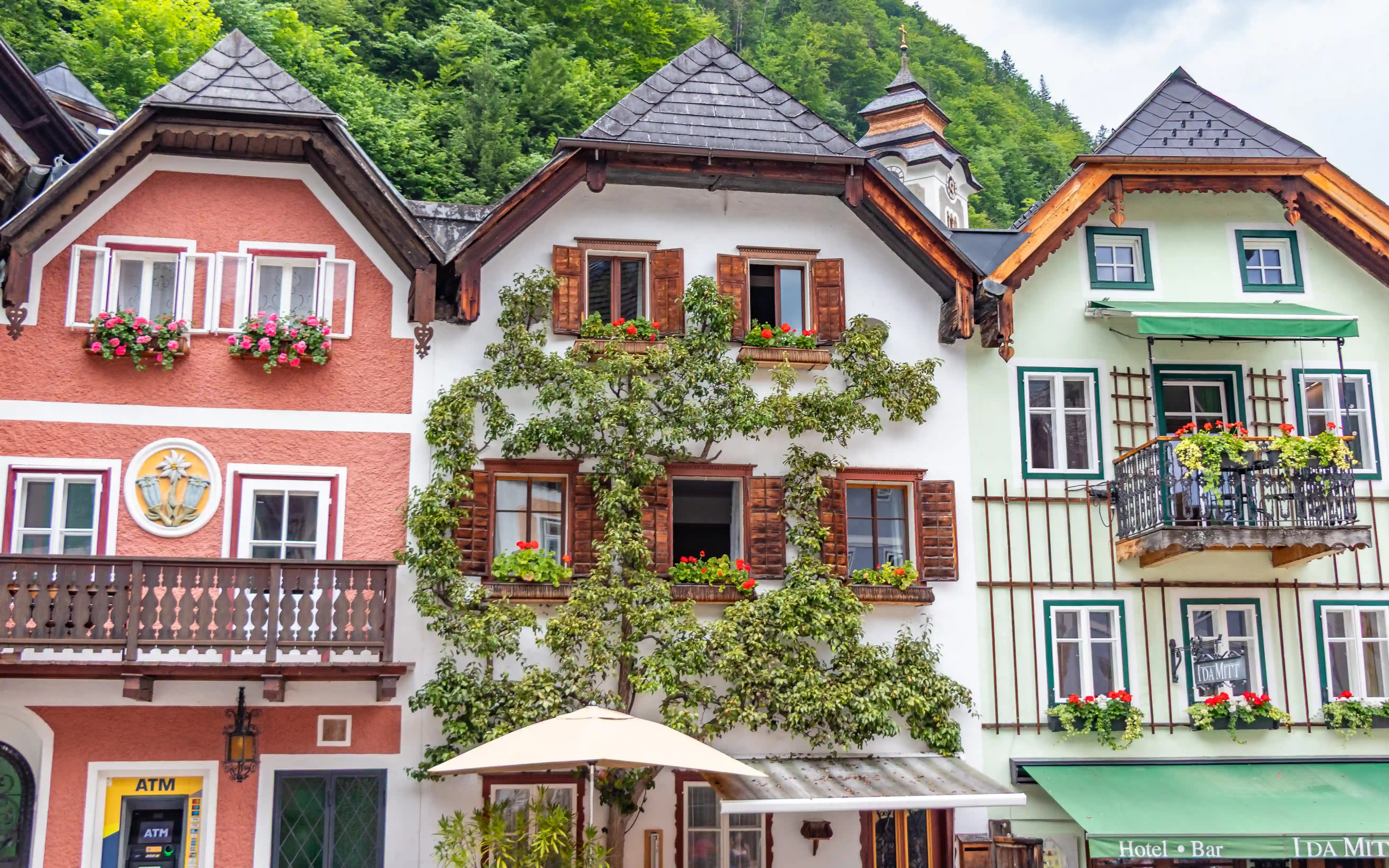Colorful traditional houses in Hallstatt with flower boxes and wooden balconies.