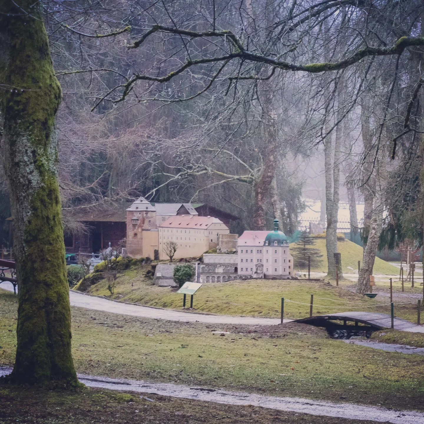 Several miniature historic buildings arranged along a curved path in Park Boheminium in Mariánské Lázně.