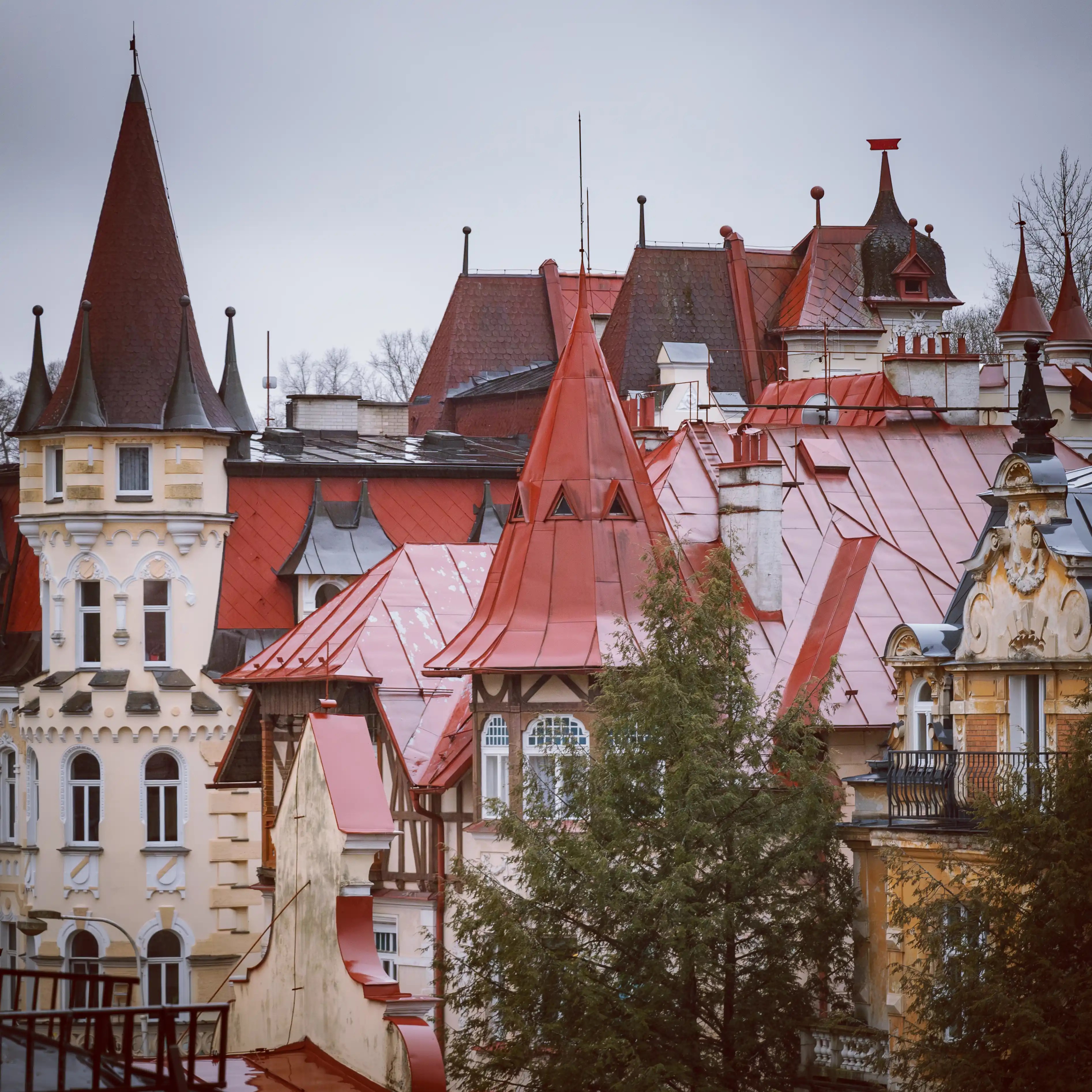 Ornate historic buildings with red rooftops and decorative towers in Mariánské Lázně.