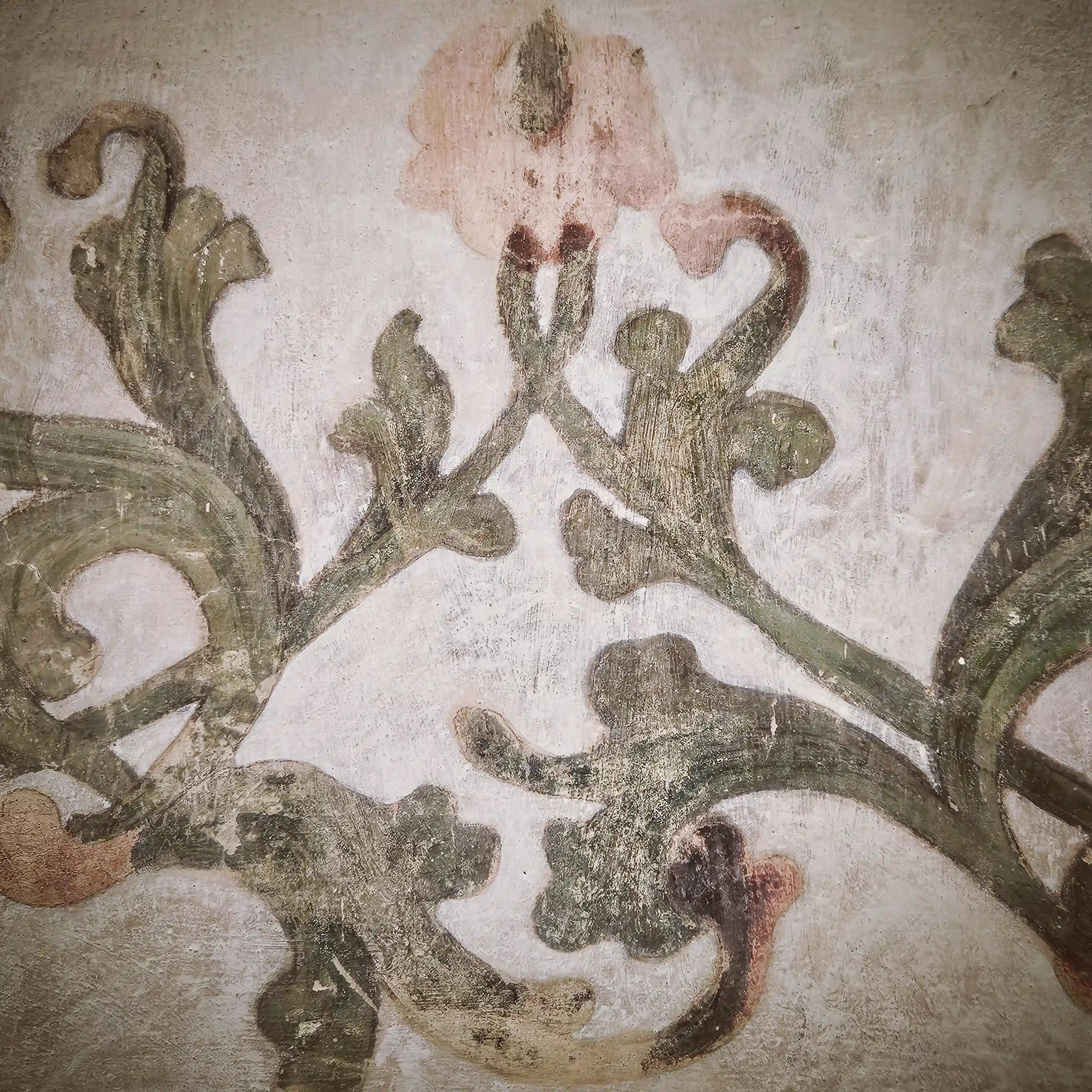 A faded painted floral design decorates a section of wall inside Kloster Blaubeuren.