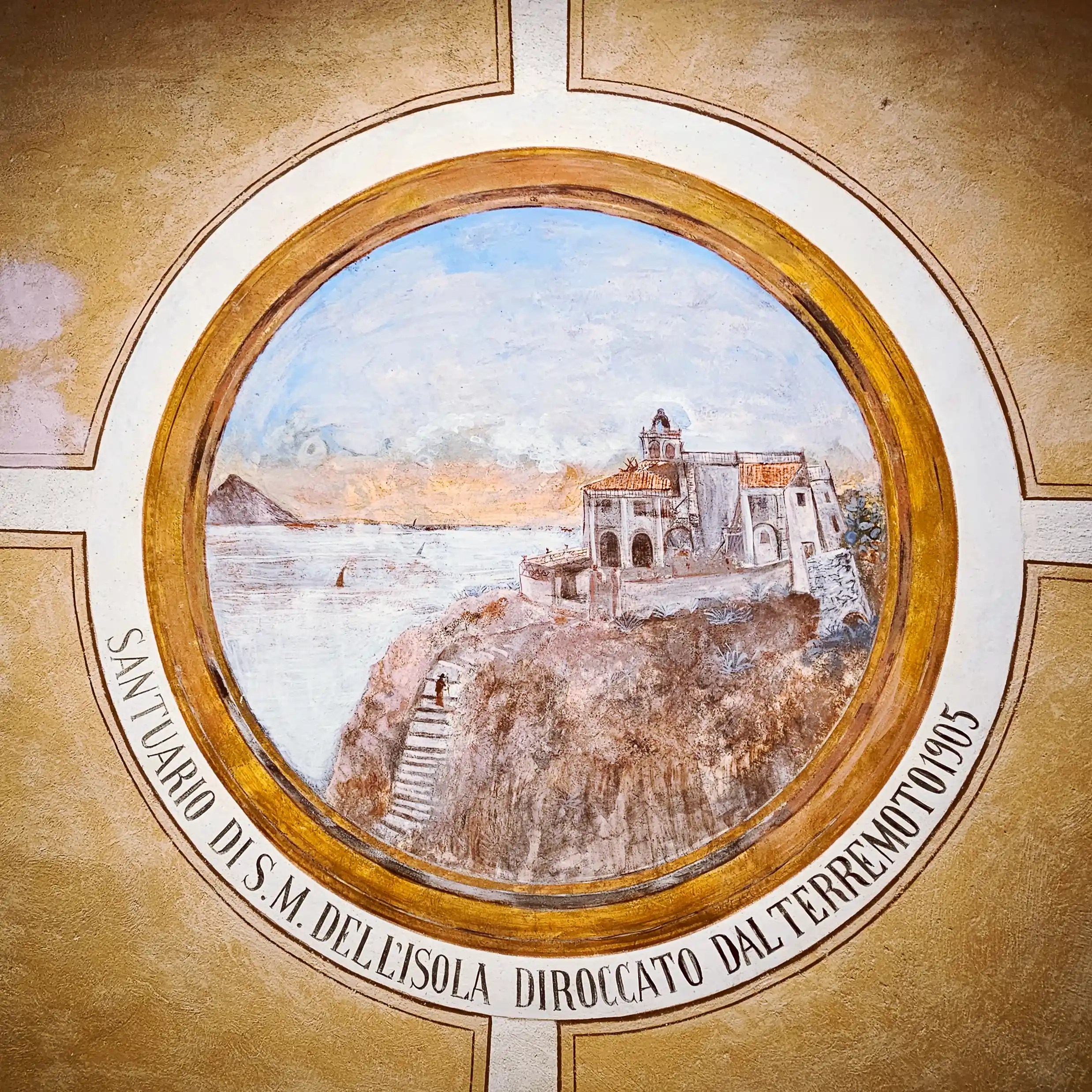 Circular framed painting of a church on a rocky island with Italian text around the border.