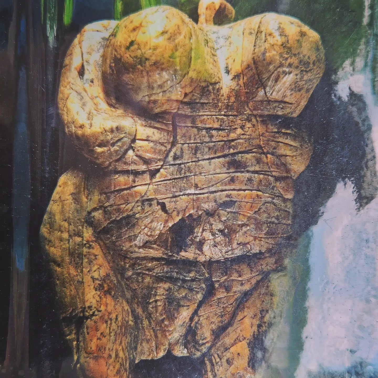 A close-up photo of an image showing the Venus of Hohle Fels figurine, carved in pale stone and displayed against a dark background.