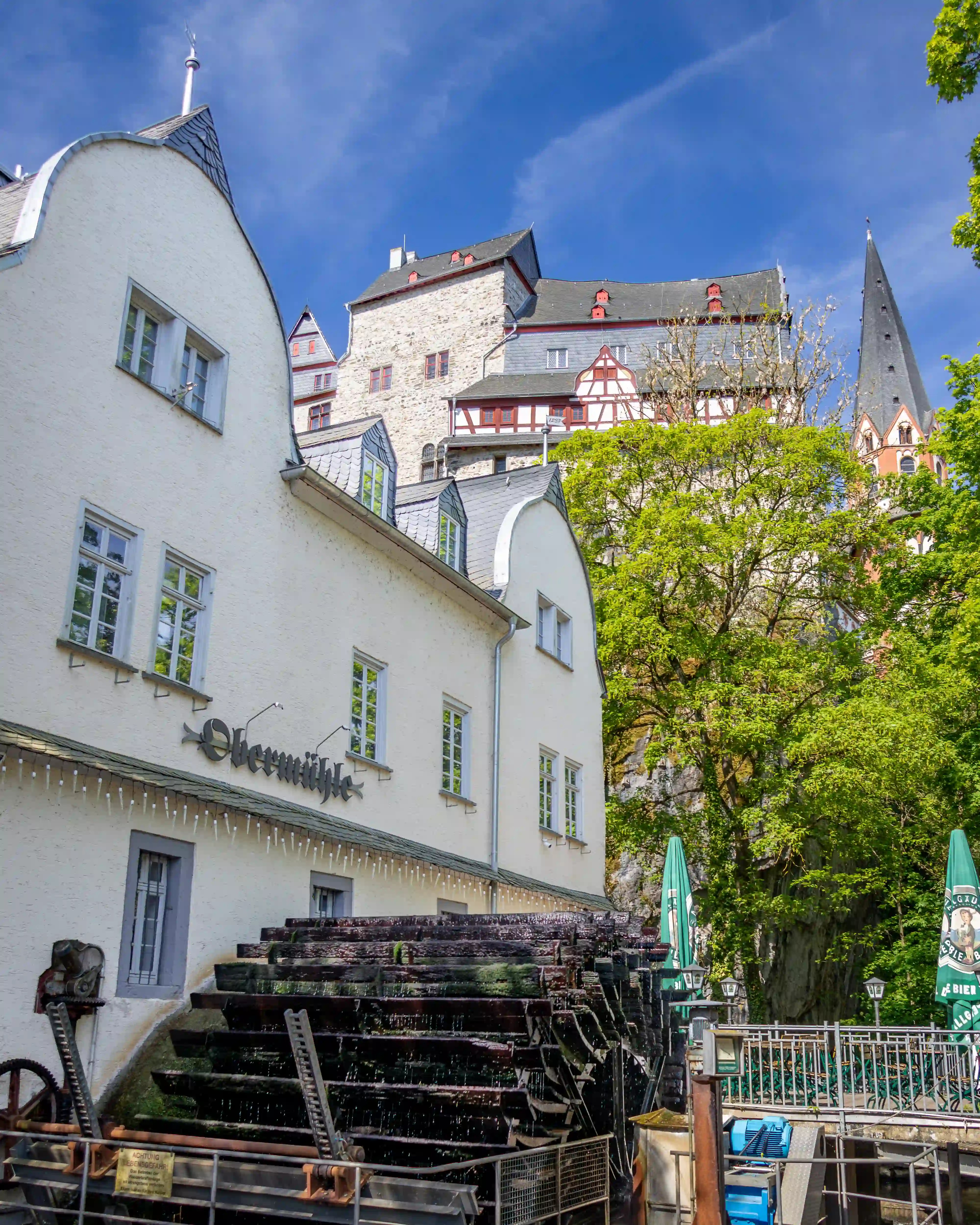 The Obermühle waterwheel below Limburg Castle and Limburger Dom in Limburg an der Lahn.