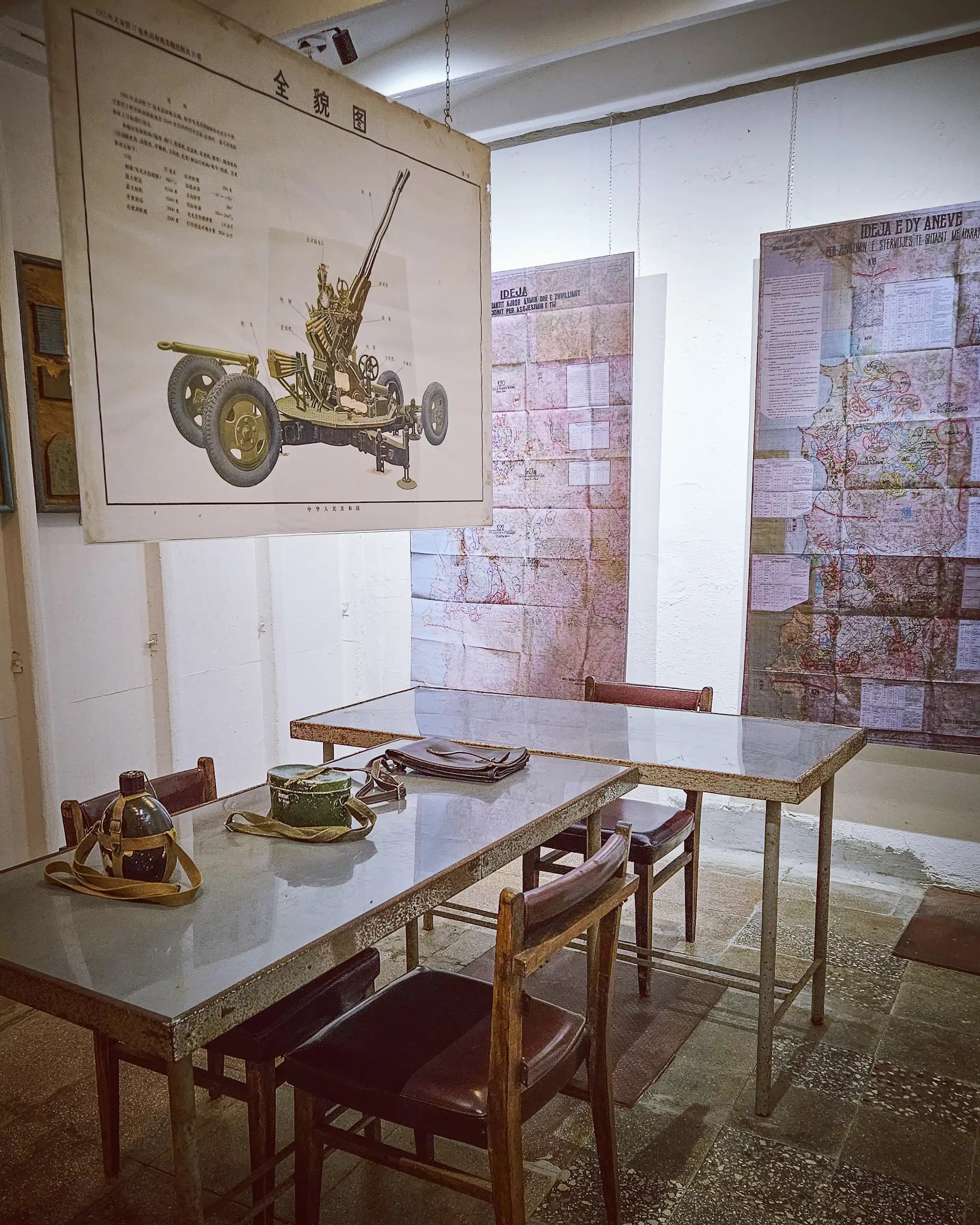 Military planning room with maps, tables, and artillery diagrams inside Bunk'Art 1 in Tirana.