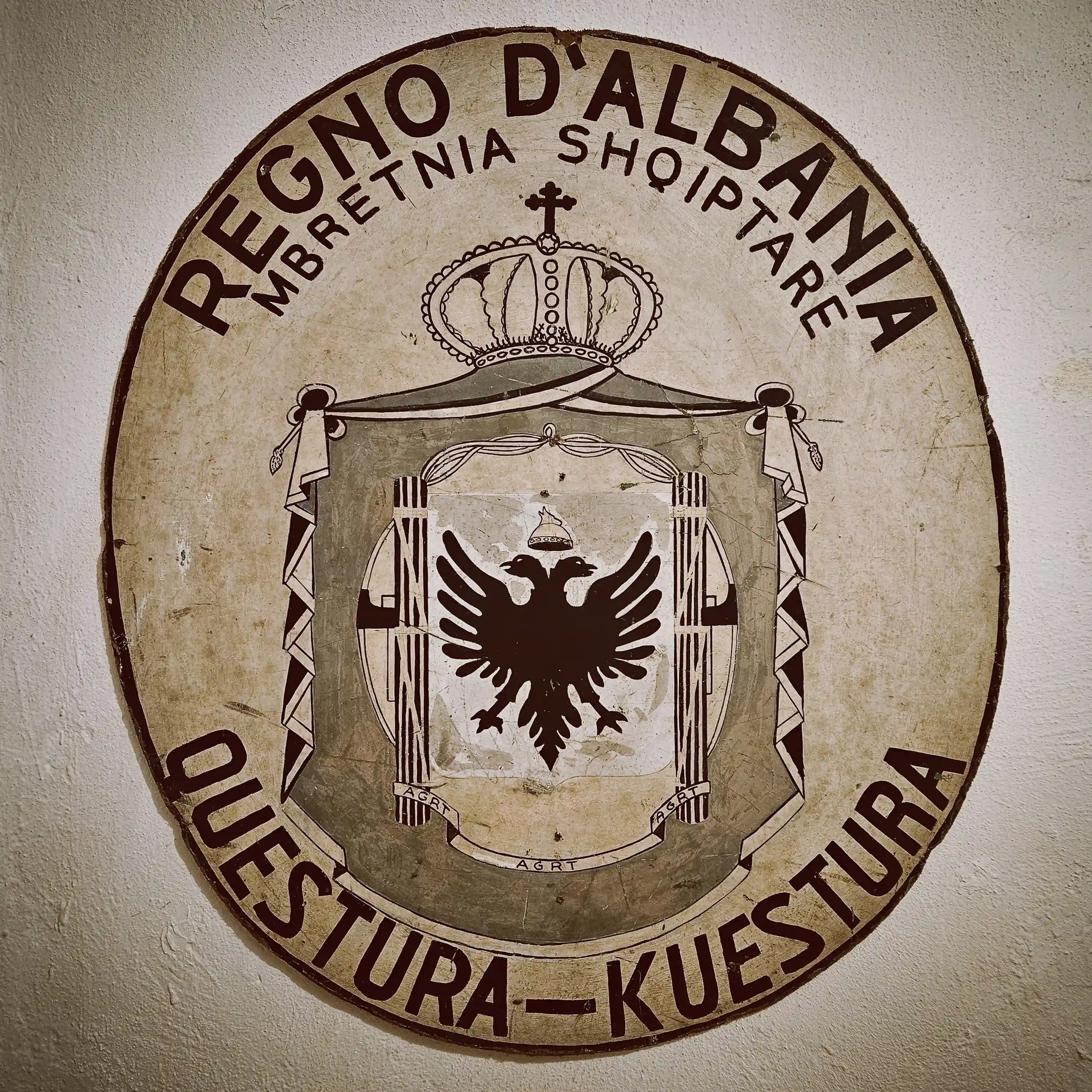 Large circular emblem of the People's Republic of Albania displayed inside Bunk'Art 1.