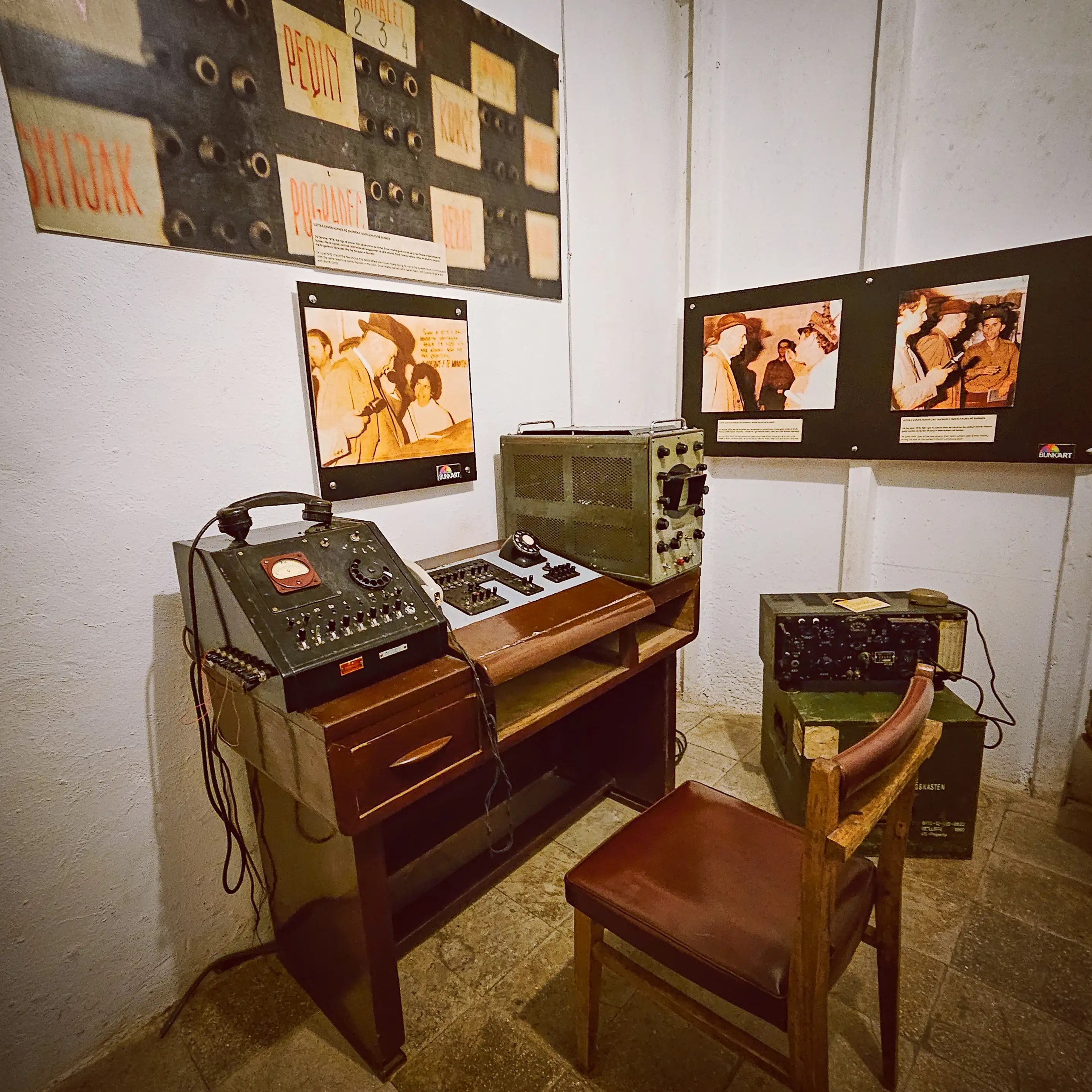 Cold War-era communications equipment and radio consoles displayed inside Bunk'Art 1.