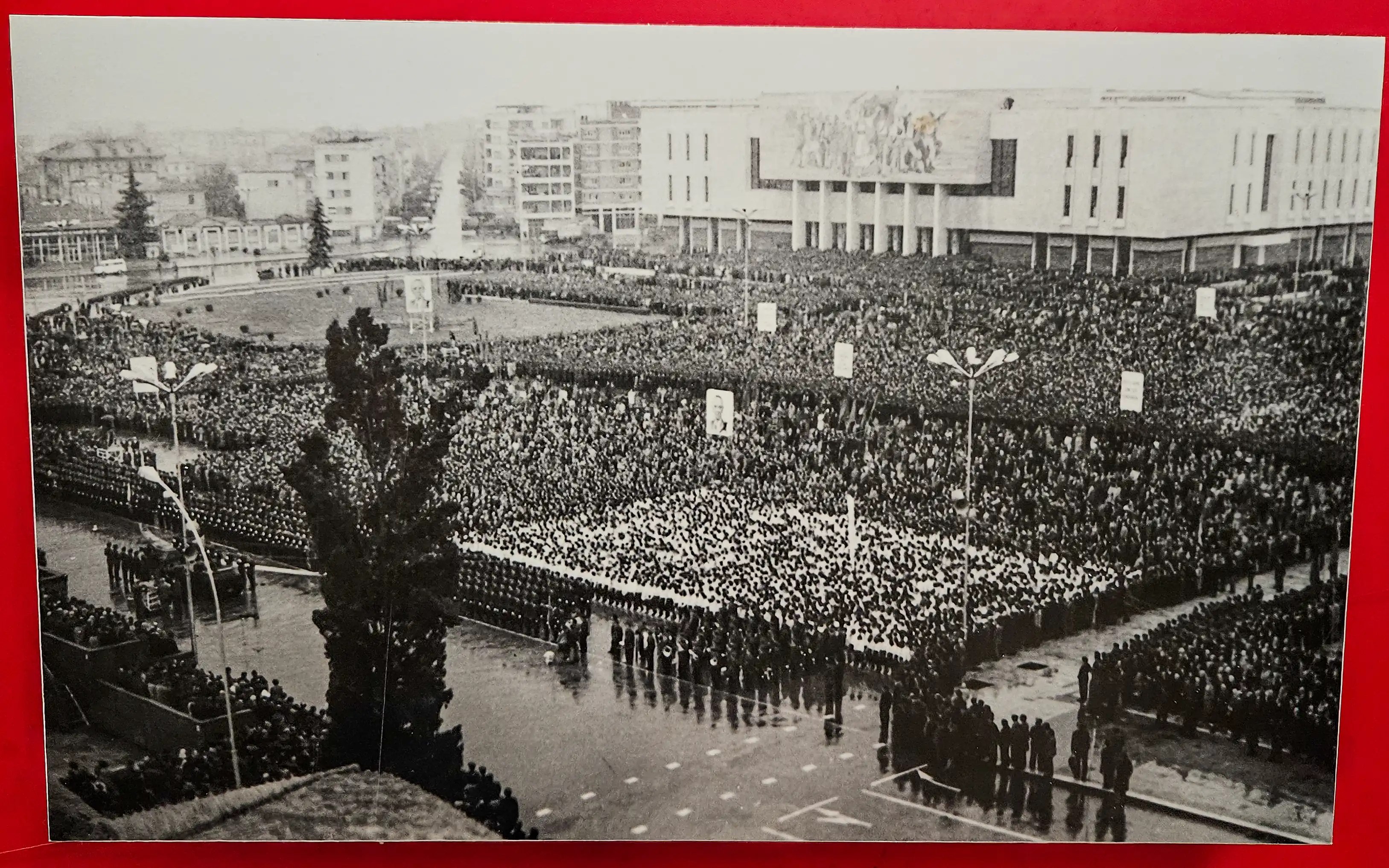 Historic black-and-white photograph showing a massive crowd gathered in Tirana during the communist era.