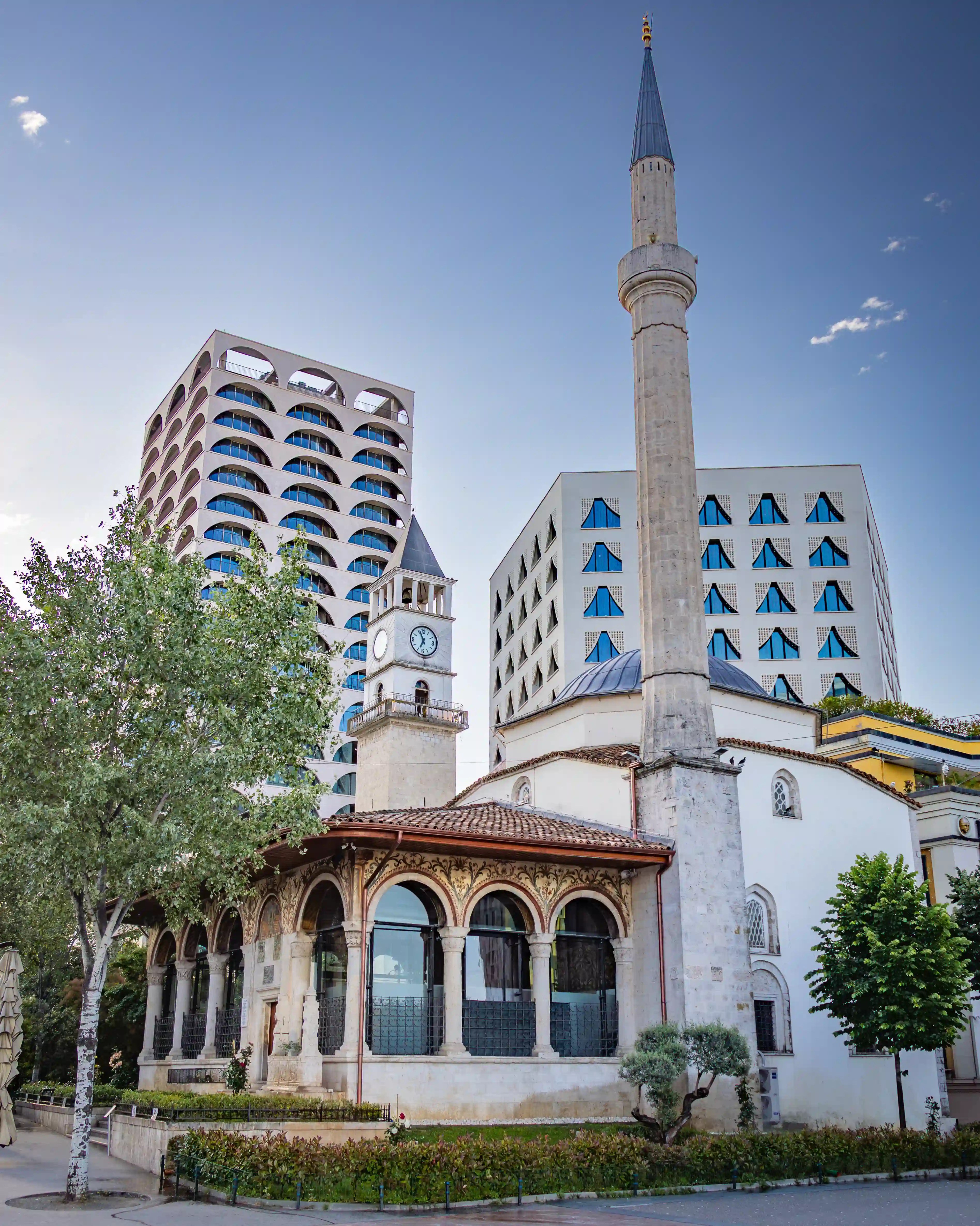 Et'hem Bej Mosque with its minaret standing among modern buildings in Skanderbeg Square, Tirana, Albania.