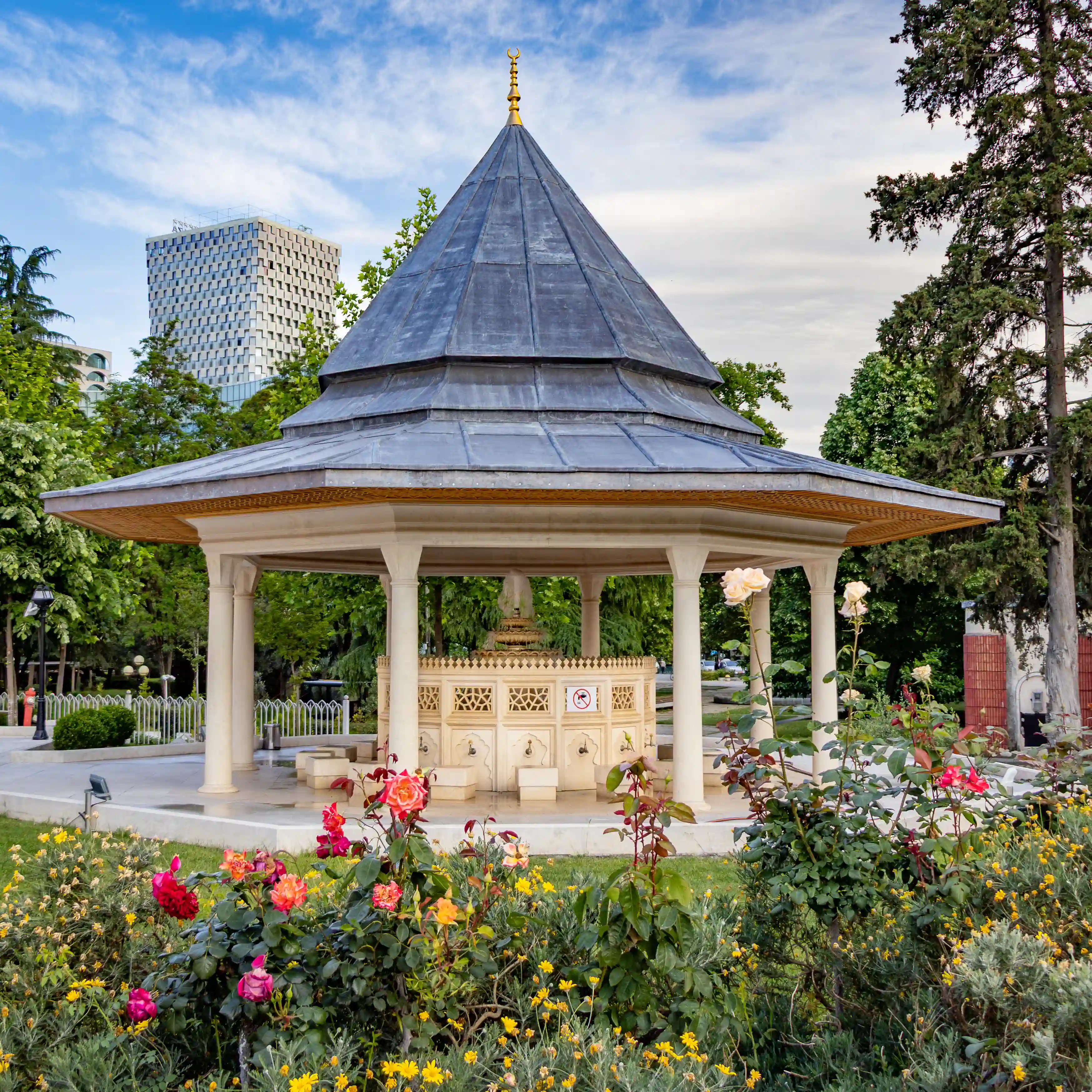Decorative pavilion and garden flowers within the grounds of the Grand Mosque of Tirana.
