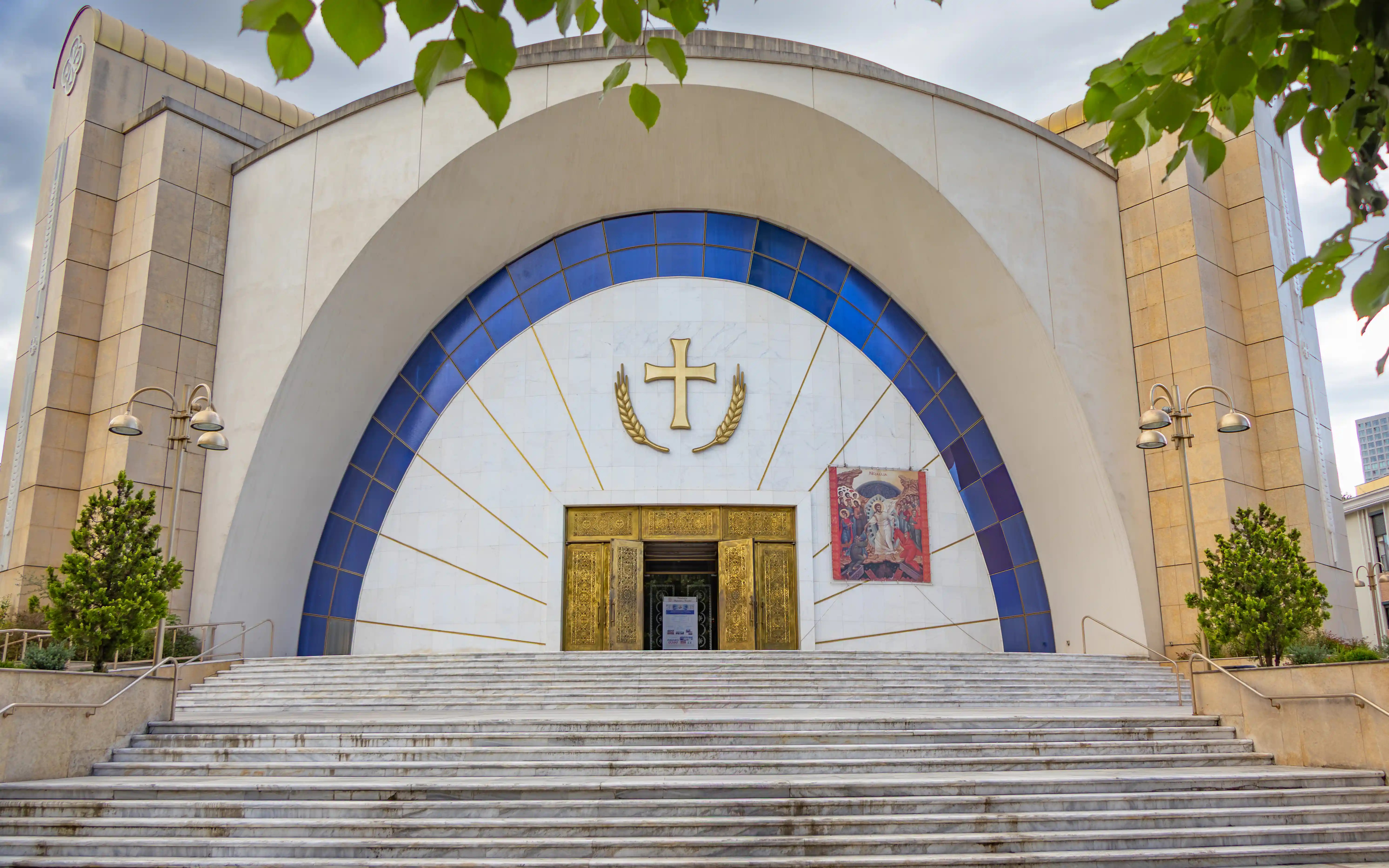 Main entrance of the Resurrection of Christ Orthodox Cathedral with broad steps and gold doors.