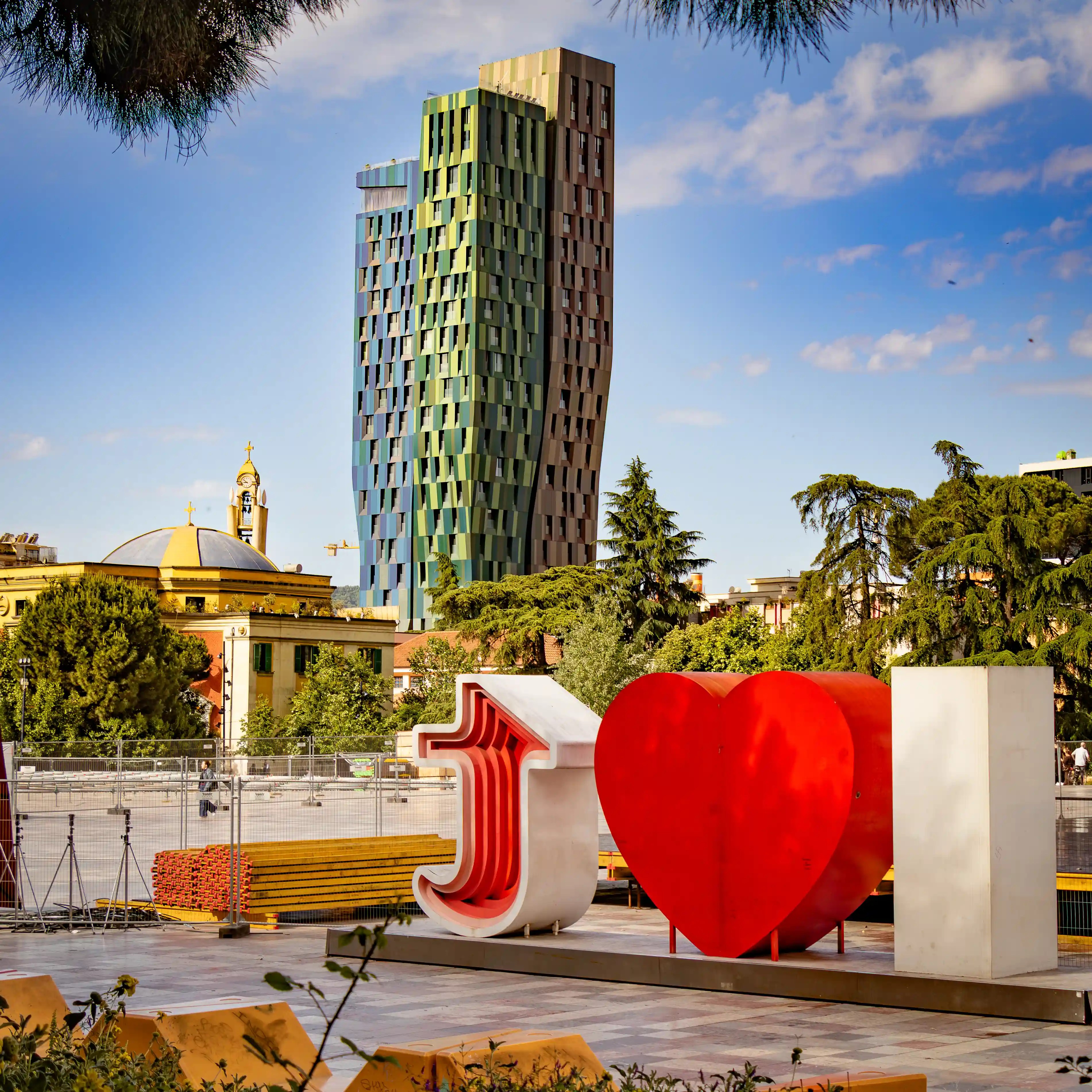 View across Skanderbeg Square in Tirana with temporary event structures and equipment set up in the plaza.
