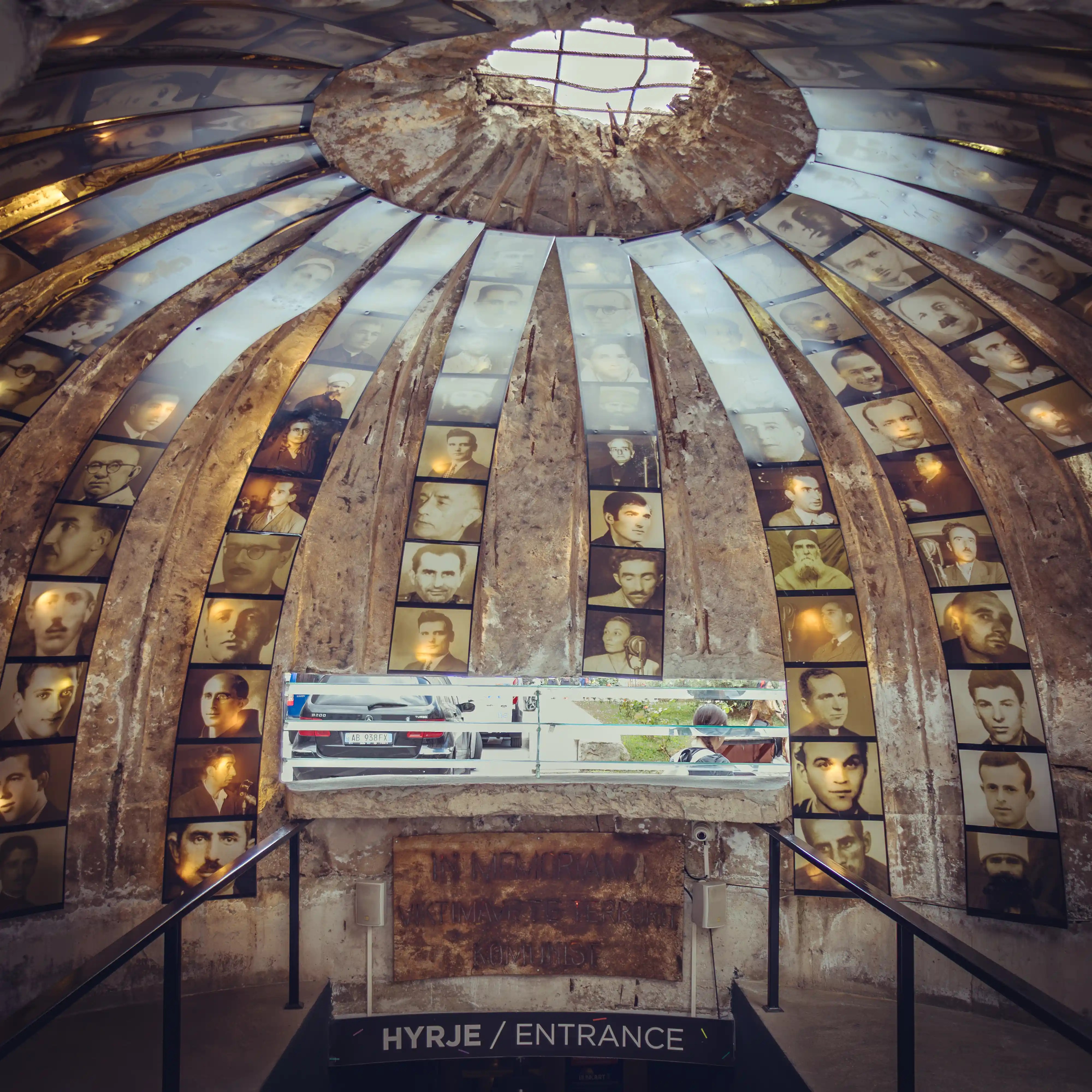 Interior of the Bunk'Art 2 entrance dome with photographs displayed along the curved walls.