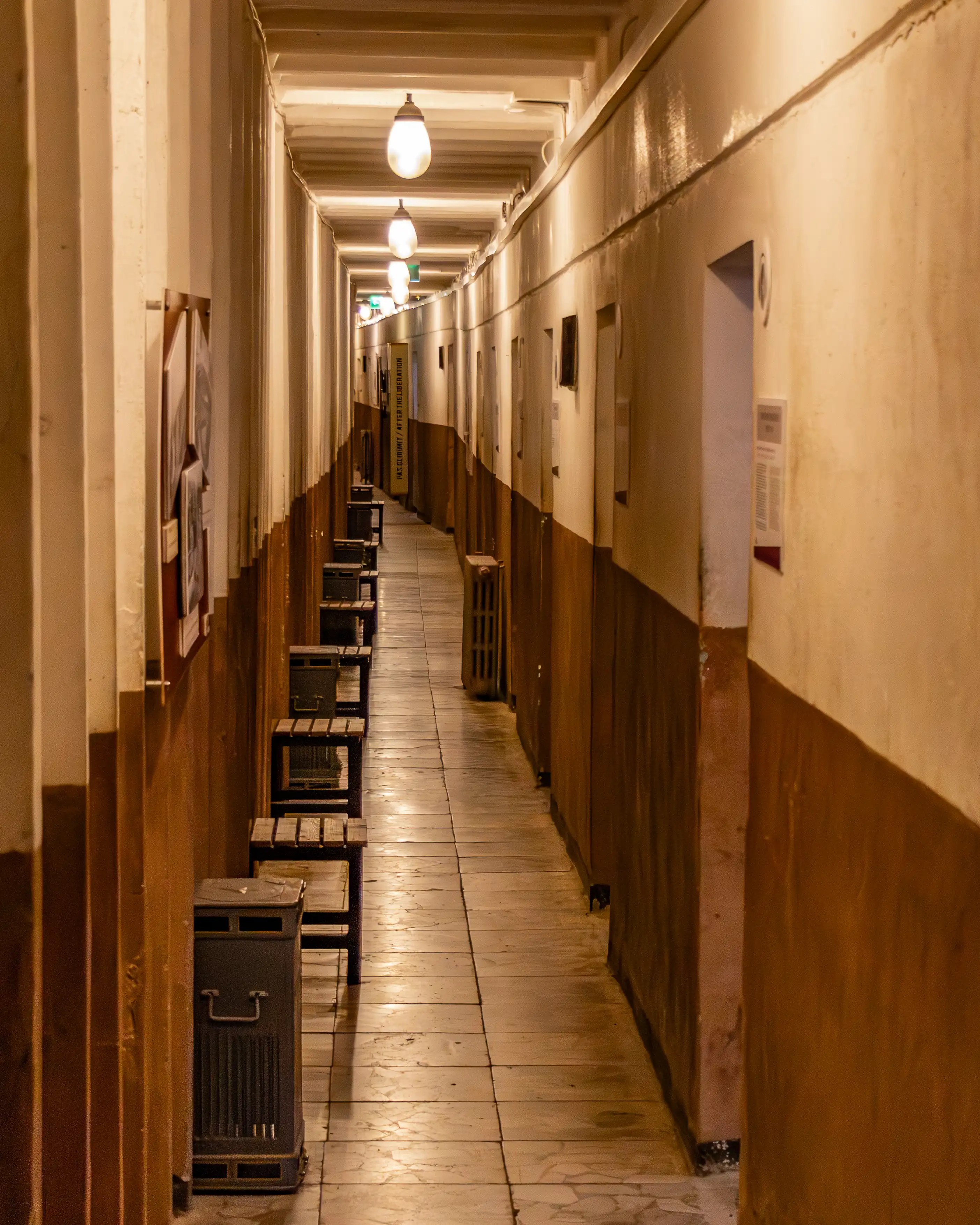 Long interior corridor lined with rooms inside Bunk'Art 1 in Tirana.
